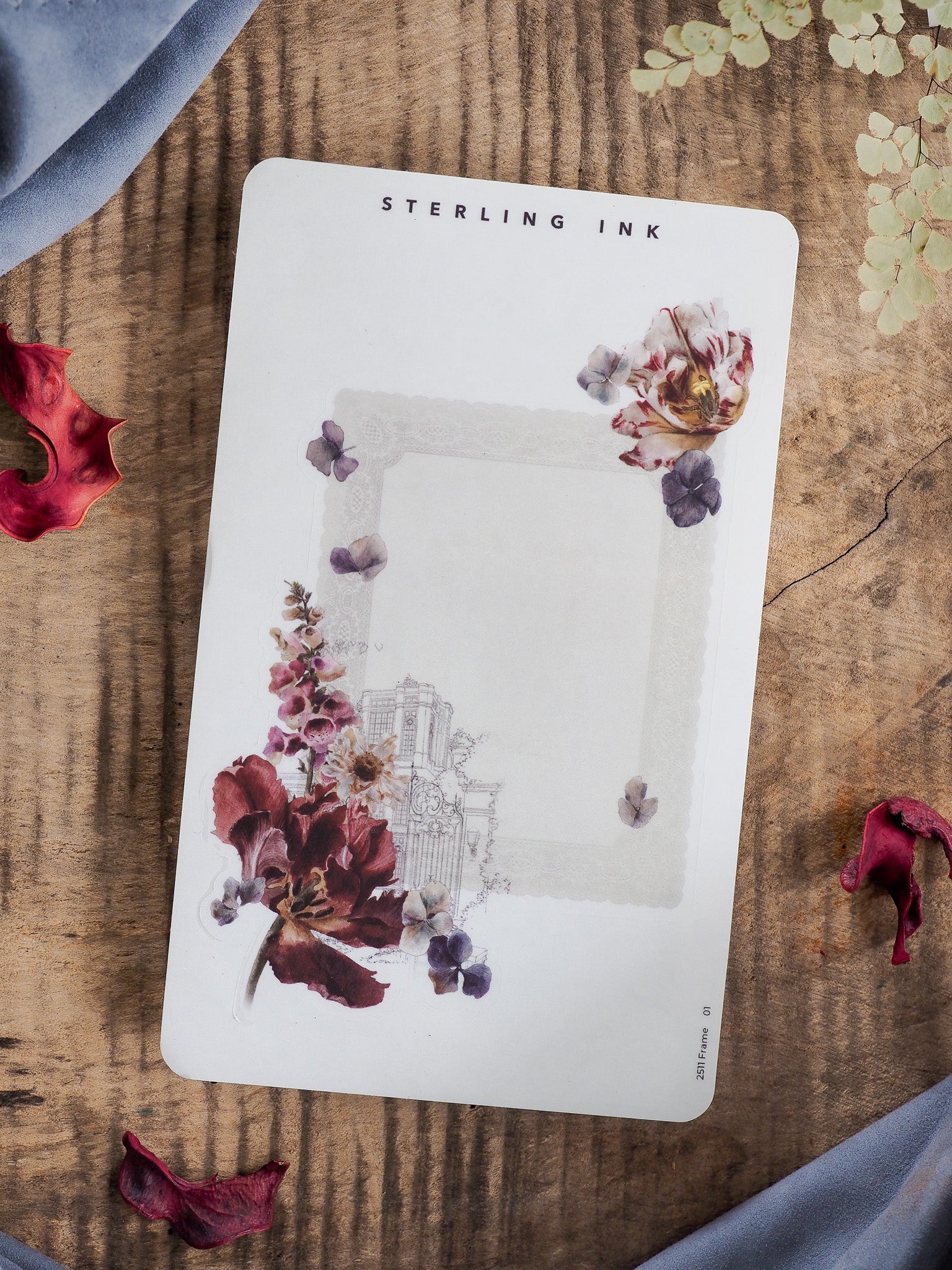 Decorative frame sticker with watercolor florals and branches surrounding a blank photo area, featuring the "Sterling Ink" label for November 2025 journaling.