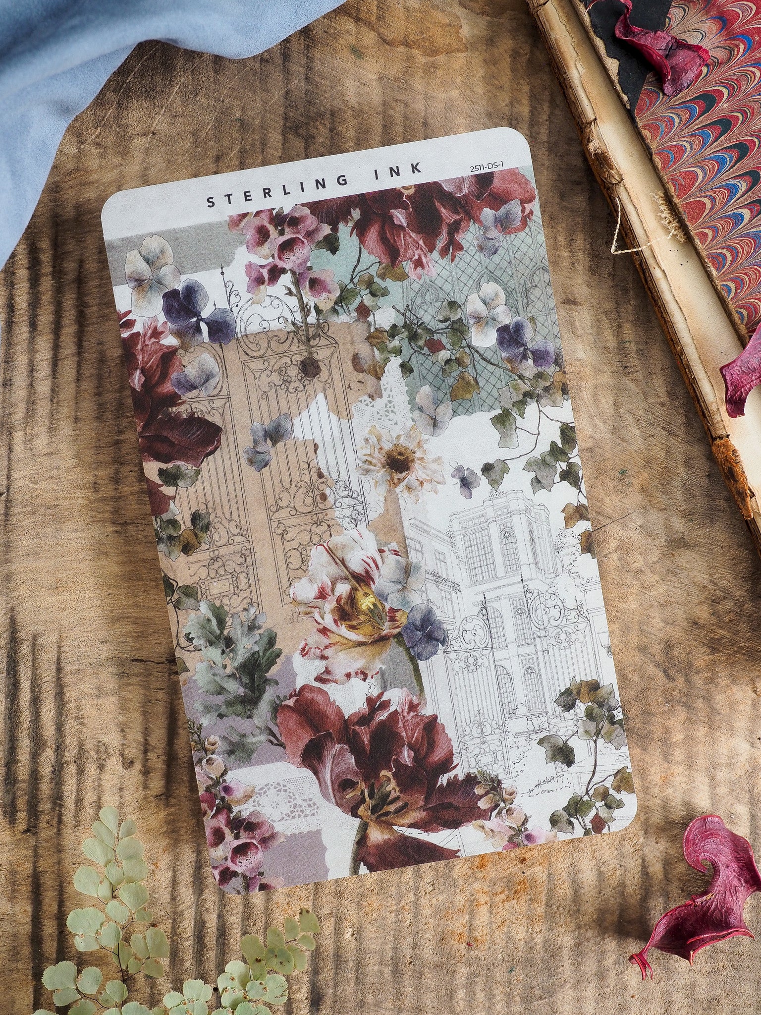 Elegant deco sheet featuring vintage floral bouquets of burgundy and dusty rose intertwined with faint architectural details and classical facade drawings.