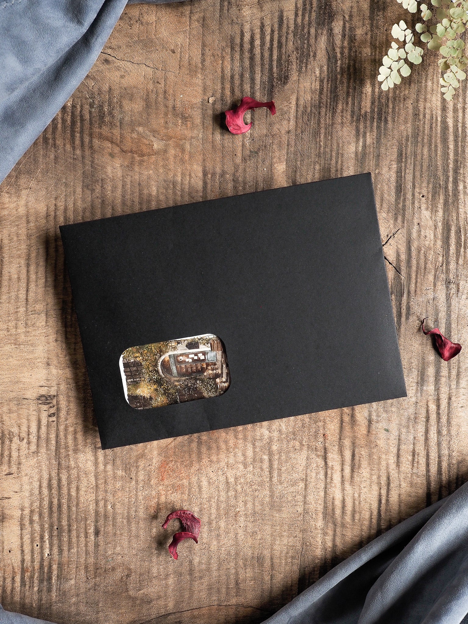 Minimalist matte black stationery card featuring a central, distressed rectangular sepia photograph, perfect for limited edition subscription kits.