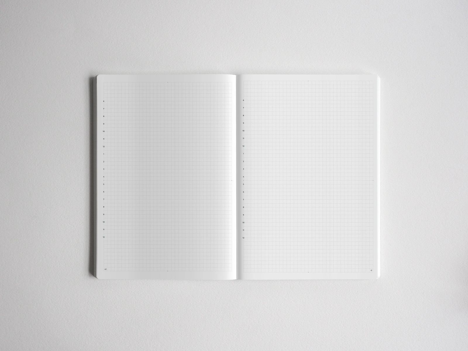 Open notebook displaying clean graph grid paper on both pages, providing structured space for organized notes, drafting, and mathematical sketching.