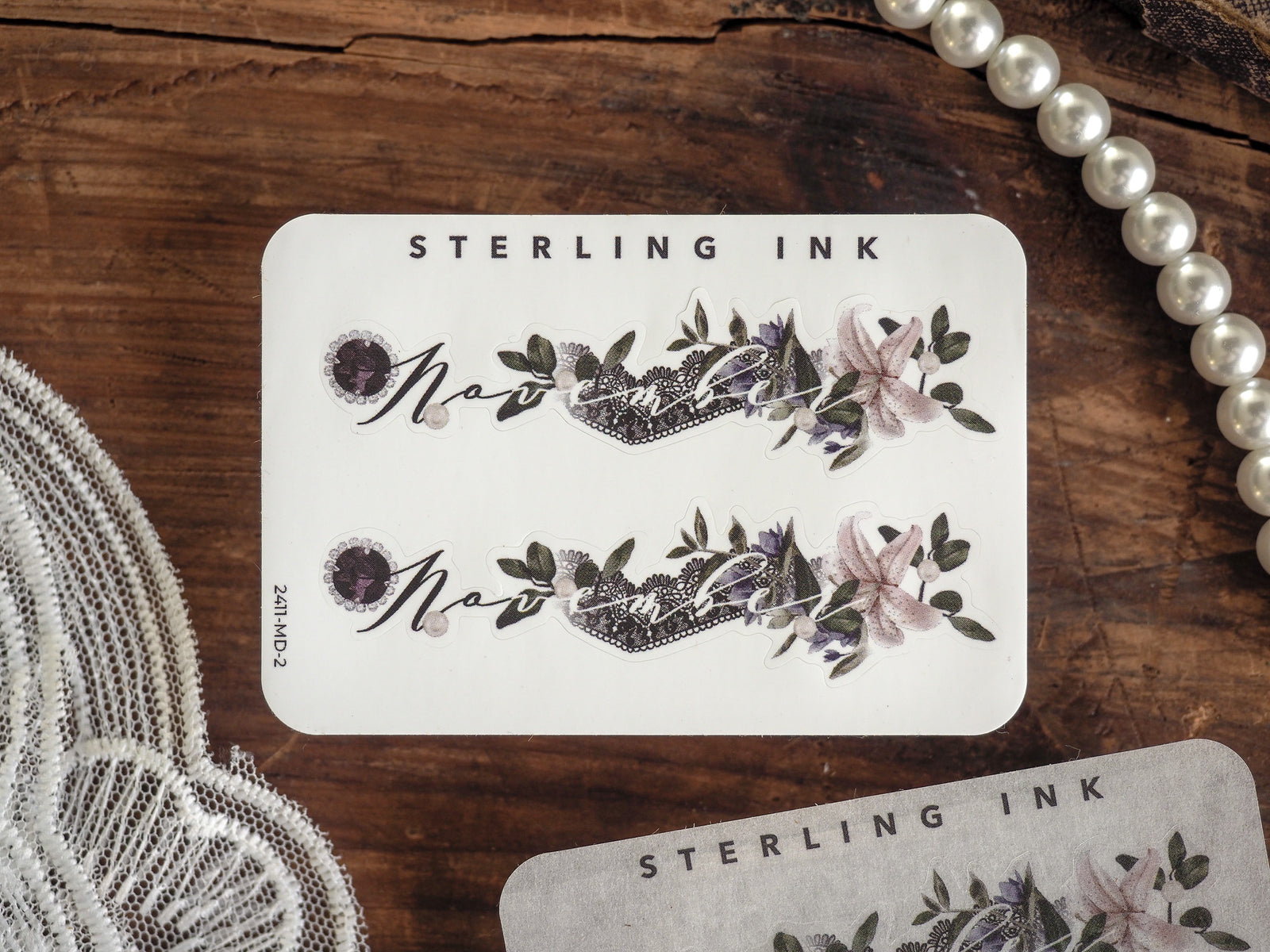 Elegant sticker sheet displaying the word "November" surrounded by delicate watercolor botanicals, perfect for seasonal journaling and crafting.
