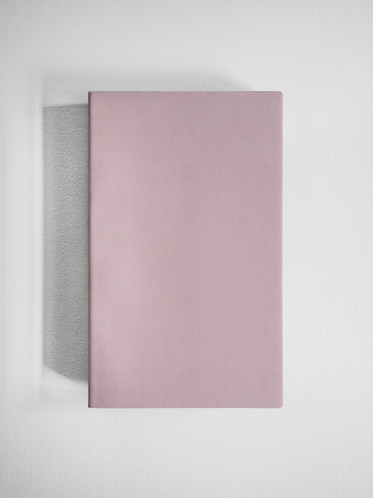 Solid, dusty rose A5 slim grid notebook featuring a minimalist, smooth cover ideal for journaling or academic note-taking.