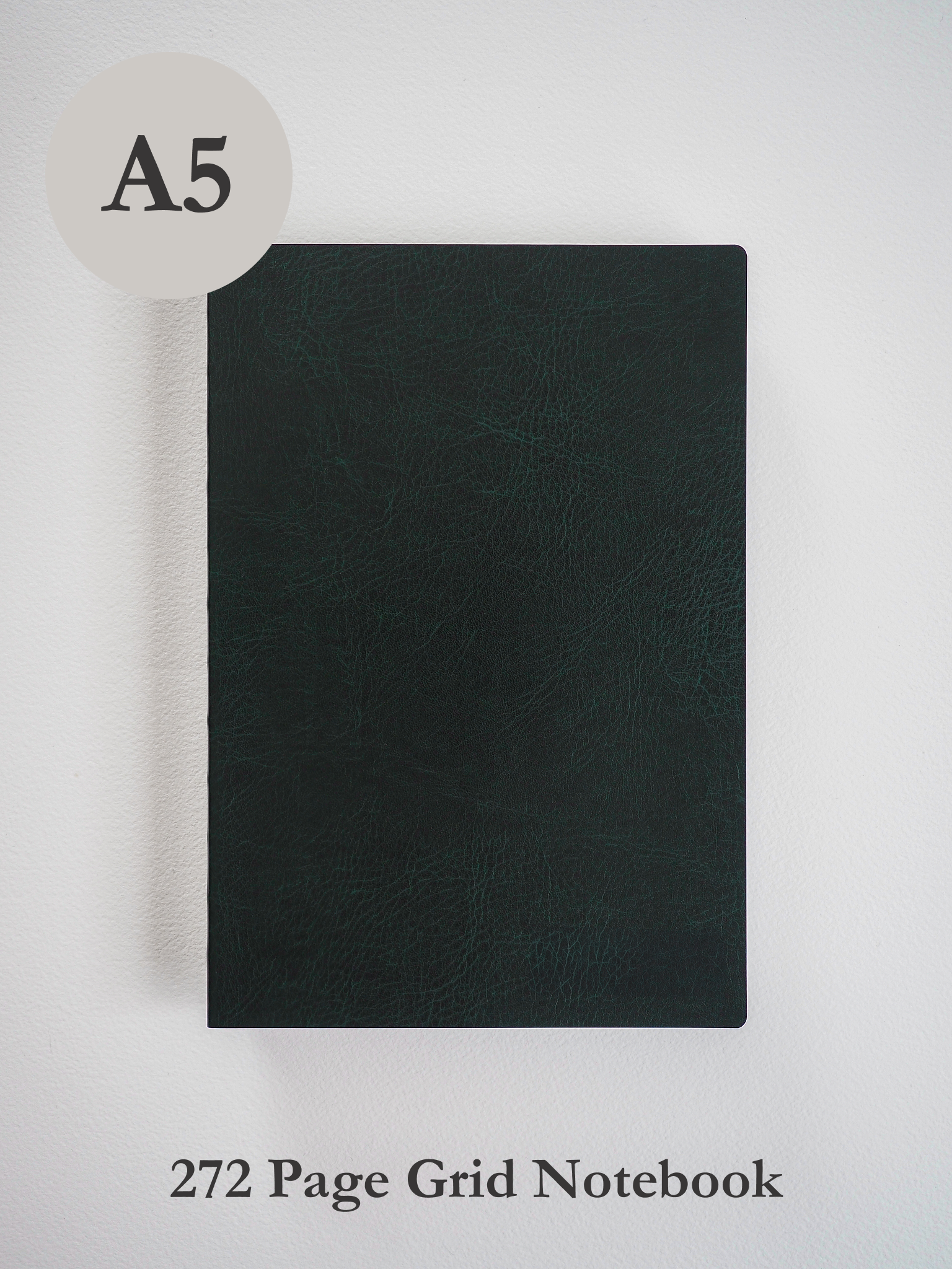 Solid A5 black notebook with a smooth, matte faux leather cover, designed for 272 pages of structured grid writing.