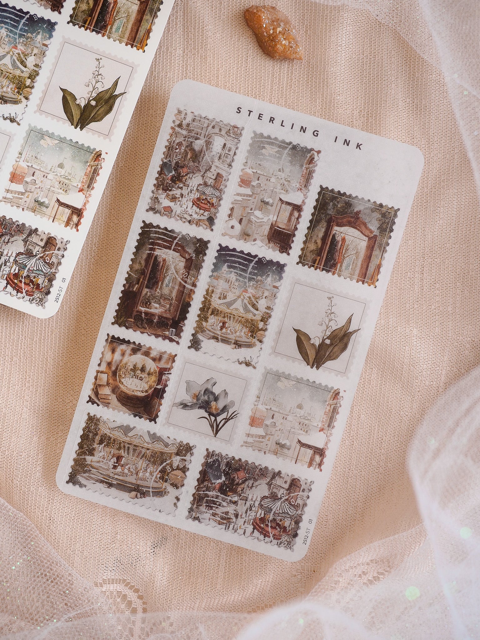 December 2025 sticker sheet featuring a rich, collage-style pattern of sepia-toned vintage stamps depicting detailed historical architecture and elegant botanical elements.