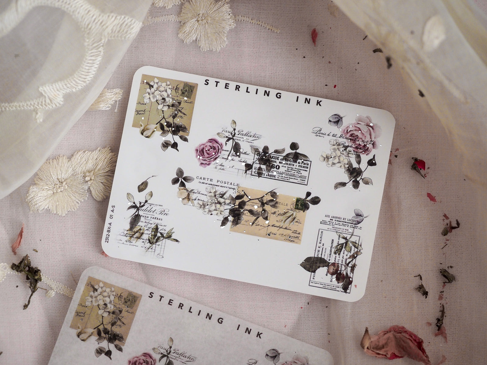 Assortment of antique-style stickers with silver foil edges, delicate floral illustrations, and printed postage stamps for vintage scrapbooking and journaling.