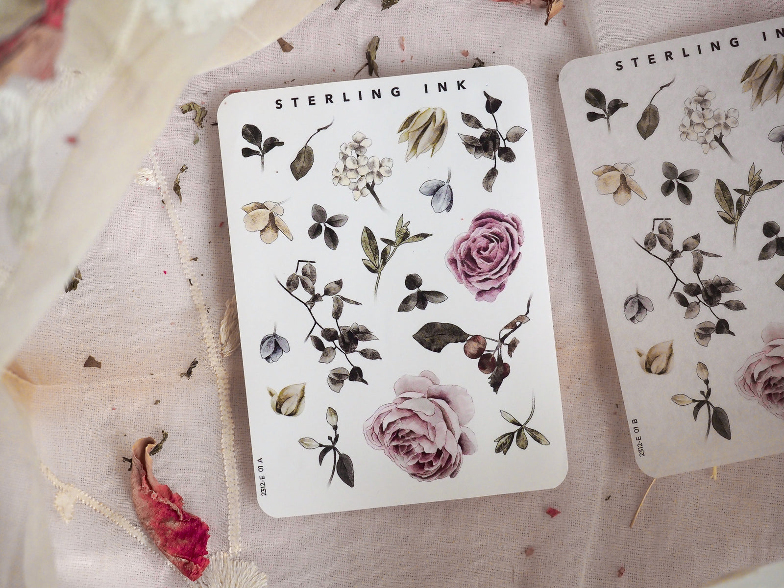 Sticker sheet featuring muted, seasonal botanical elements including blush roses, sepia-toned leaves, and delicate floral sprigs.