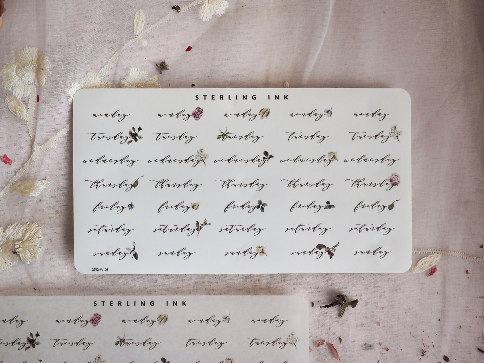 Delicate white weekly calendar stickers for December 2023, featuring hand-drawn botanical accents and labeled days perfect for year-end planning.