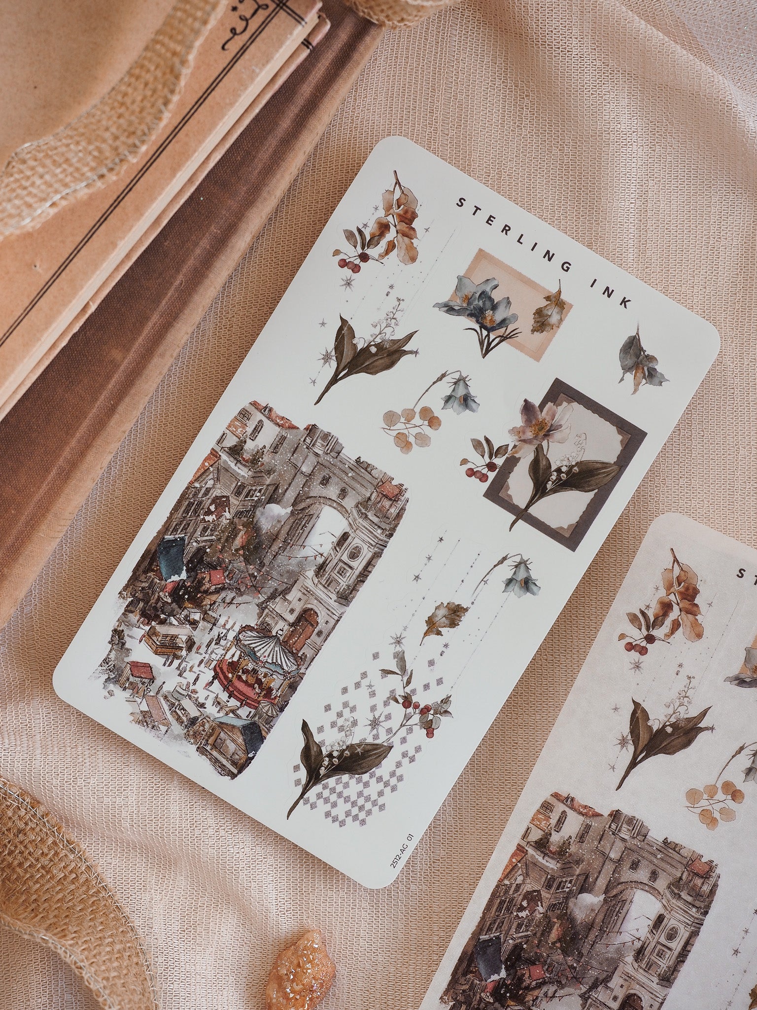 Seasonal arrangement sticker set featuring muted sepia tones, antique botanical wreath clusters, and intricate December street scene illustrations.