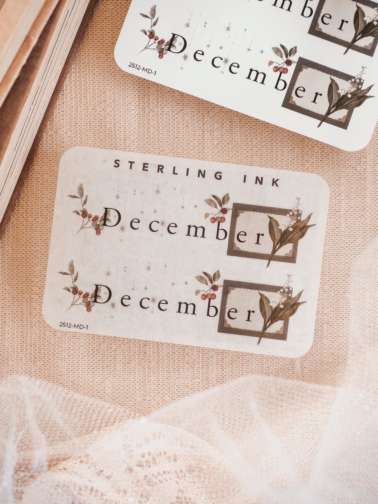 Elegant white sticker labels for December, featuring rustic botanical prints and coordinating berries framed in subtle sepia tones.