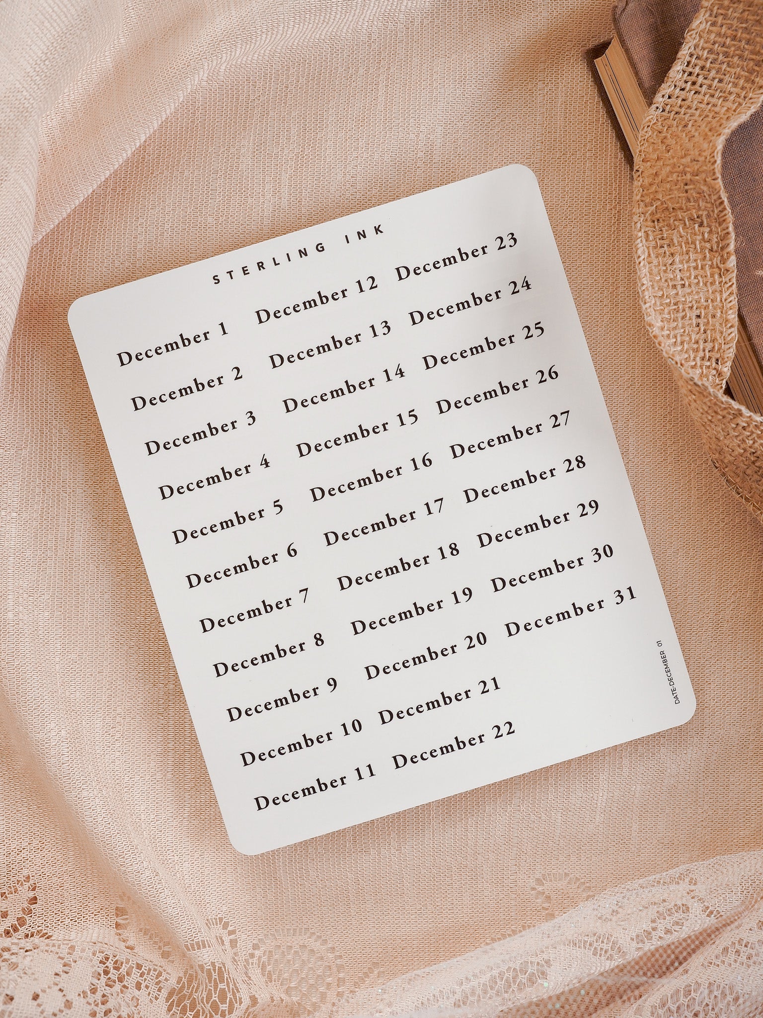 White sticker sheet featuring a clean, organized calendar layout for December 2025, listing all dates 1 through 31 in black text from STERLING INK.