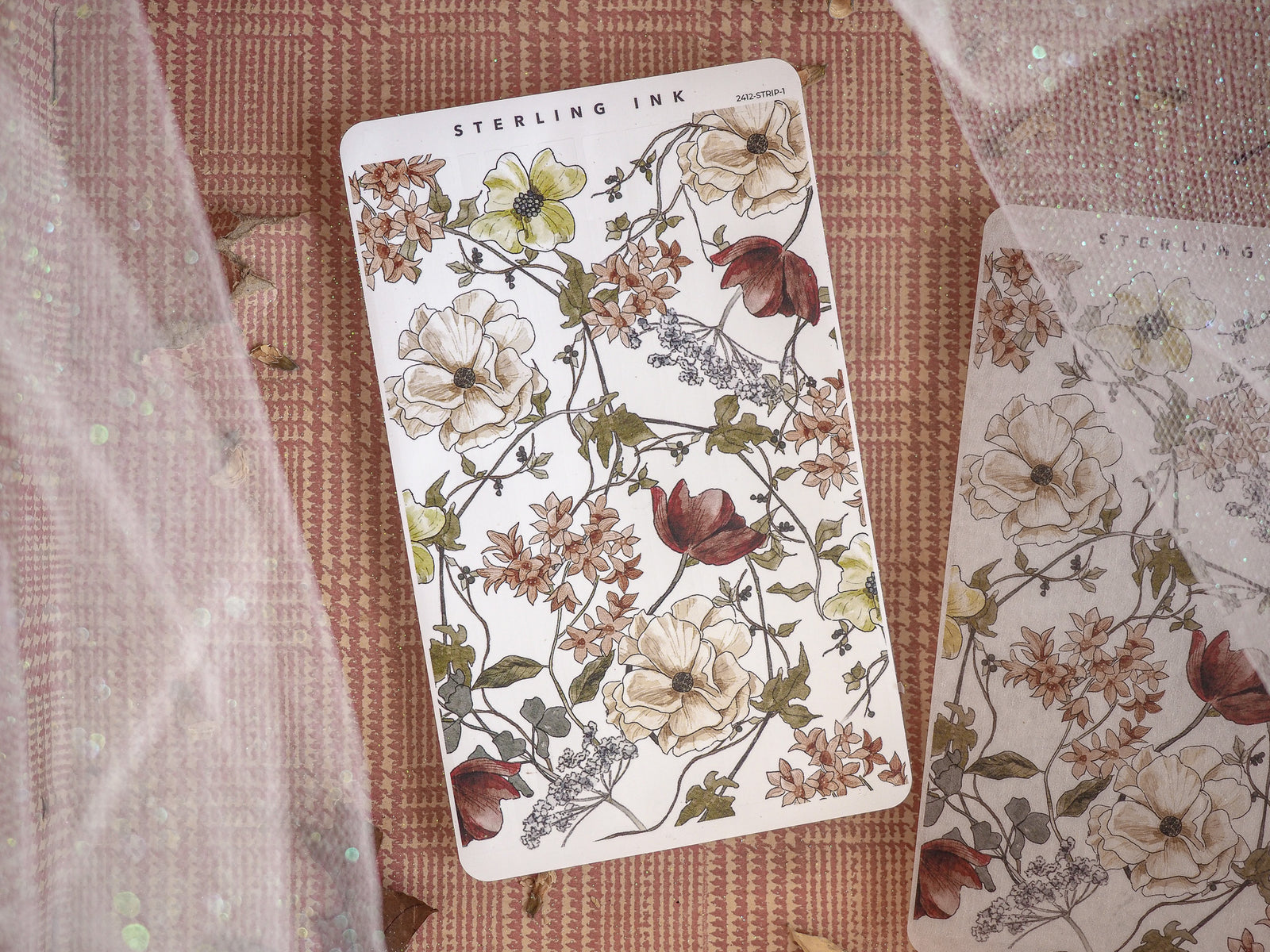 Intricate botanical sticker sheet featuring an autumnal theme, displaying detailed illustrations of blooms and foliage in creams, burnt reds, and rich fall tones.