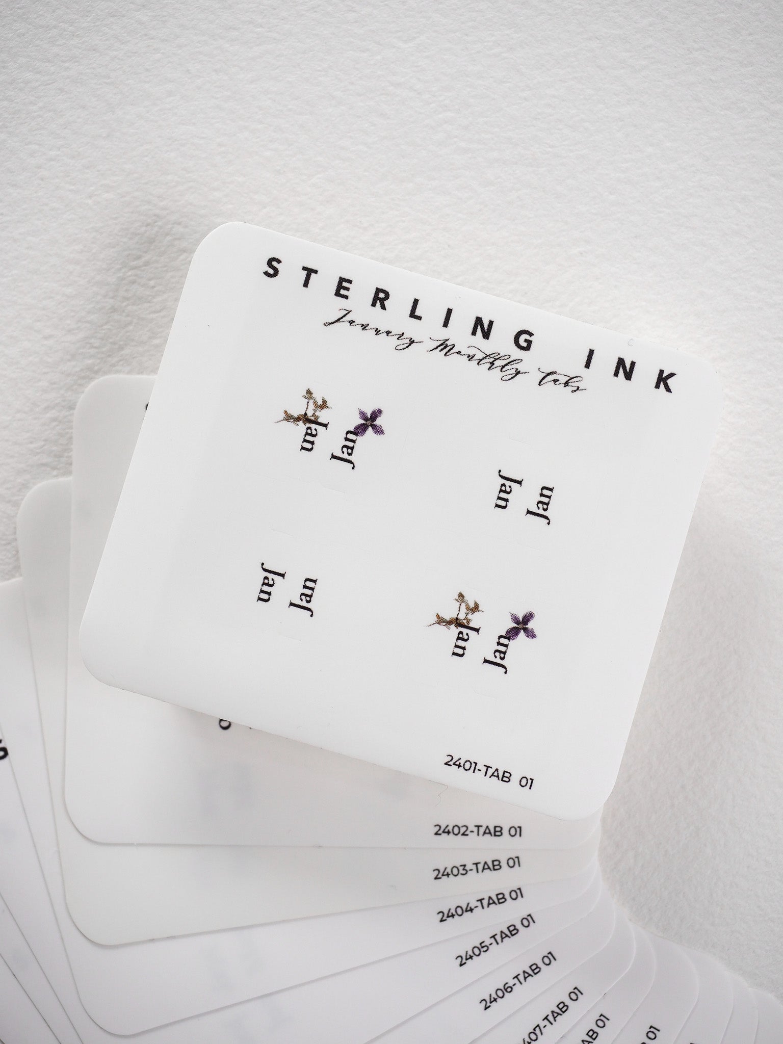 Decorative white planner tab stickers featuring "Sterling Journey Butterfly Ink" branding and delicate golden butterfly and floral illustrations for journaling.