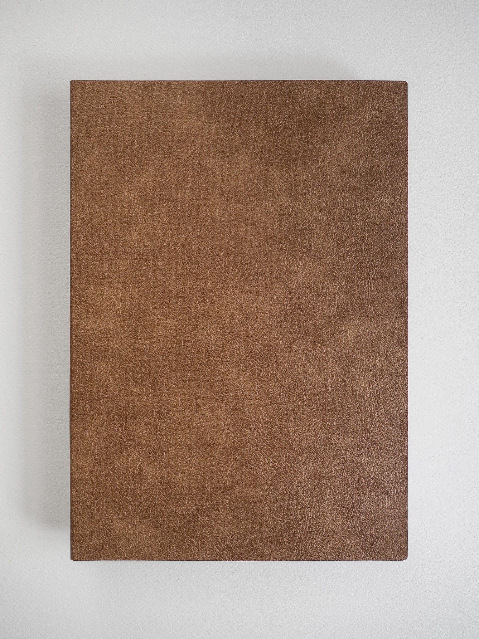 Rich, solid cognac brown notebook cover with a fine, subtle leather texture, ready for B5 grid journaling.