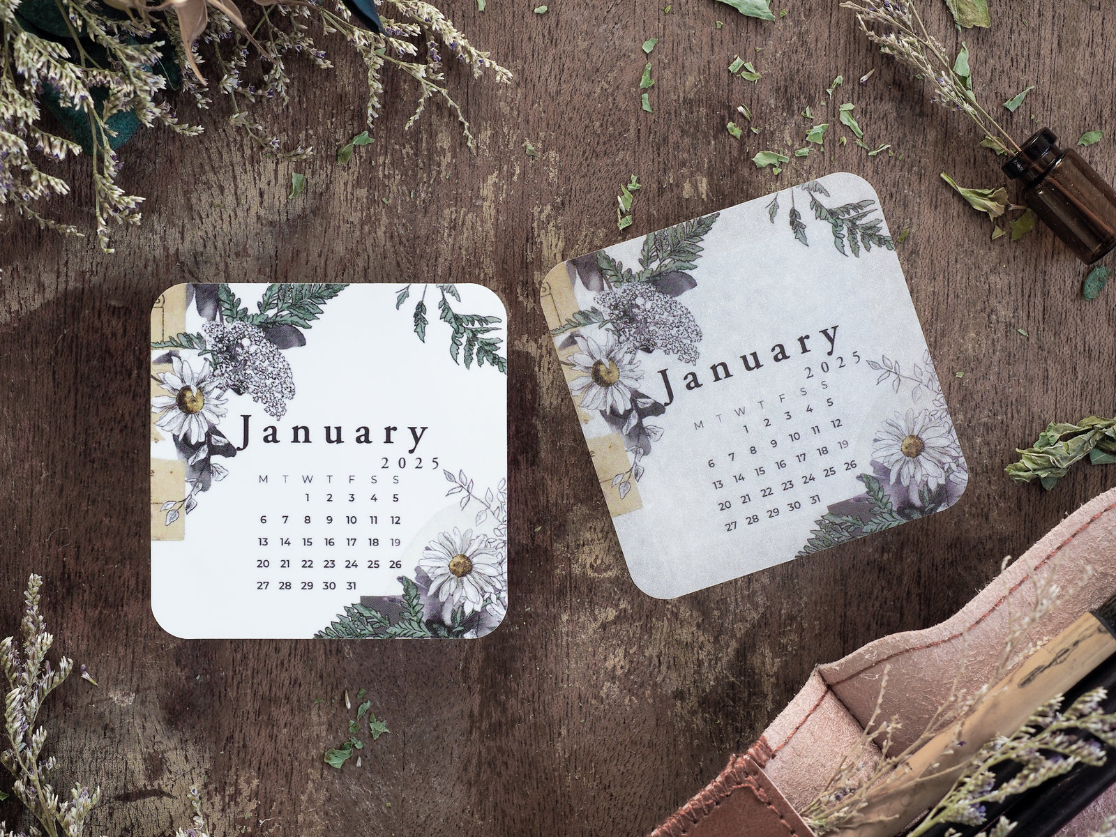 A rustic January 2025 monthly calendar featuring a watercolor floral design with deep green foliage and elegant white bloom accents.