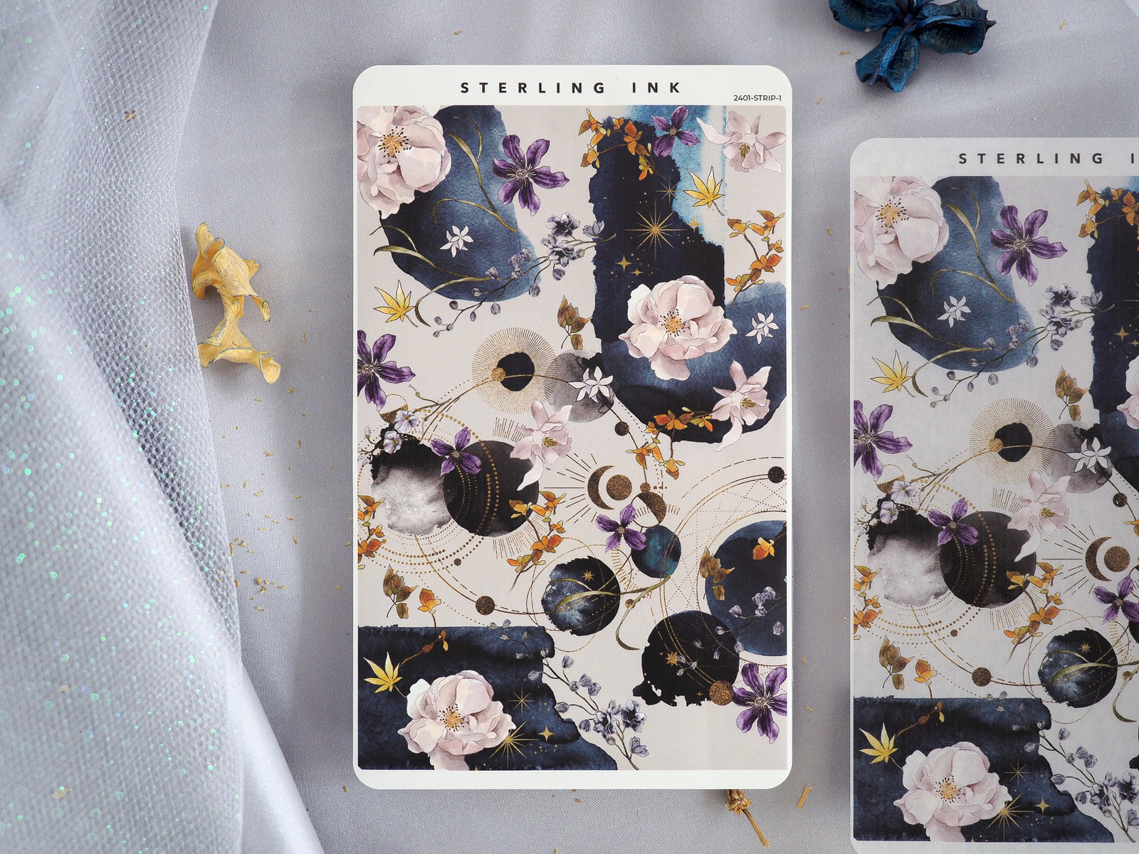 Celestial floral sticker sheet featuring deep navy backgrounds, soft watercolor blossoms, pink accents, and gold foil moons.