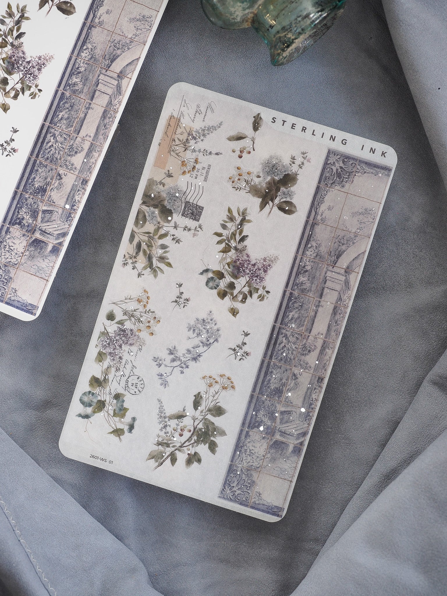 Elegant washi strip stickers featuring a vintage botanical pattern of deep green leaves and wildflowers mixed with subtle silver foil accents and architectural engravings.