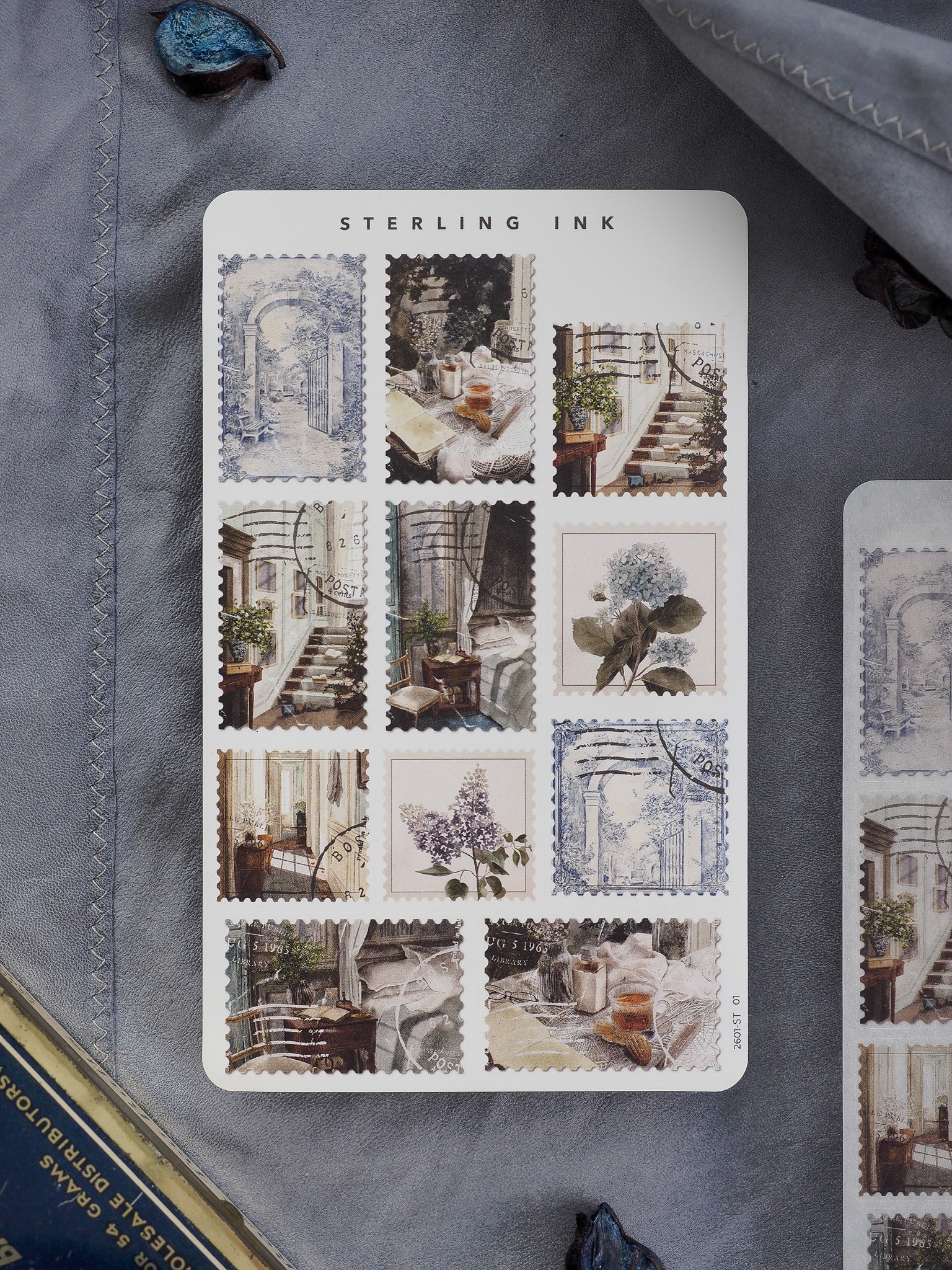Decorative sheet of vintage "Sterling Ink" stickers featuring antique blue and sepia illustrations of architectural vignettes and botanical sketches.