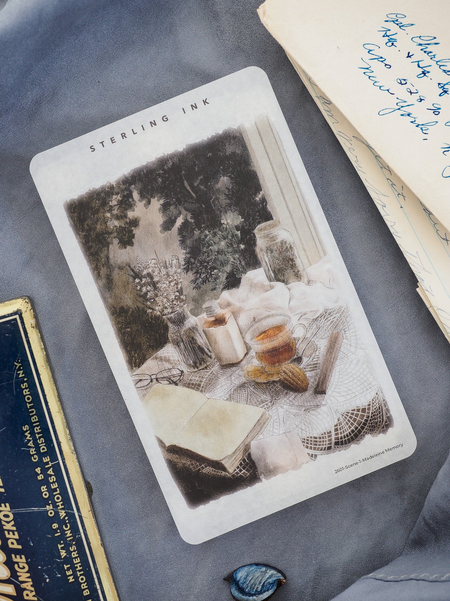 Watercolor sticker featuring a vintage indoor scene of a draped lace table, delicate teacups, and soft flowers, titled "Madeleine Memory."