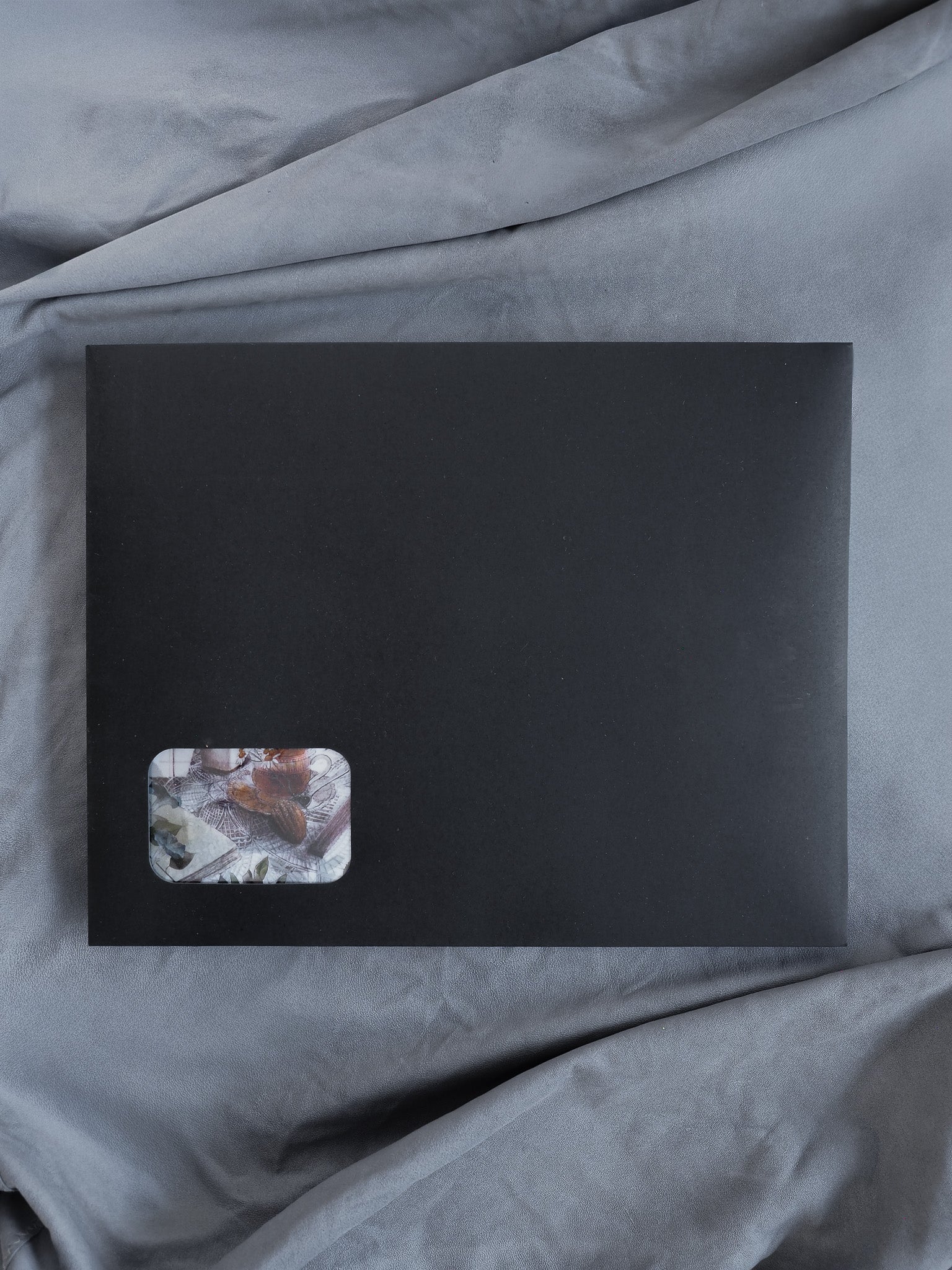 Minimalist black planner kit showcasing a nature-inspired corner accent of muted earth tones and botanical elements for journaling and organization.