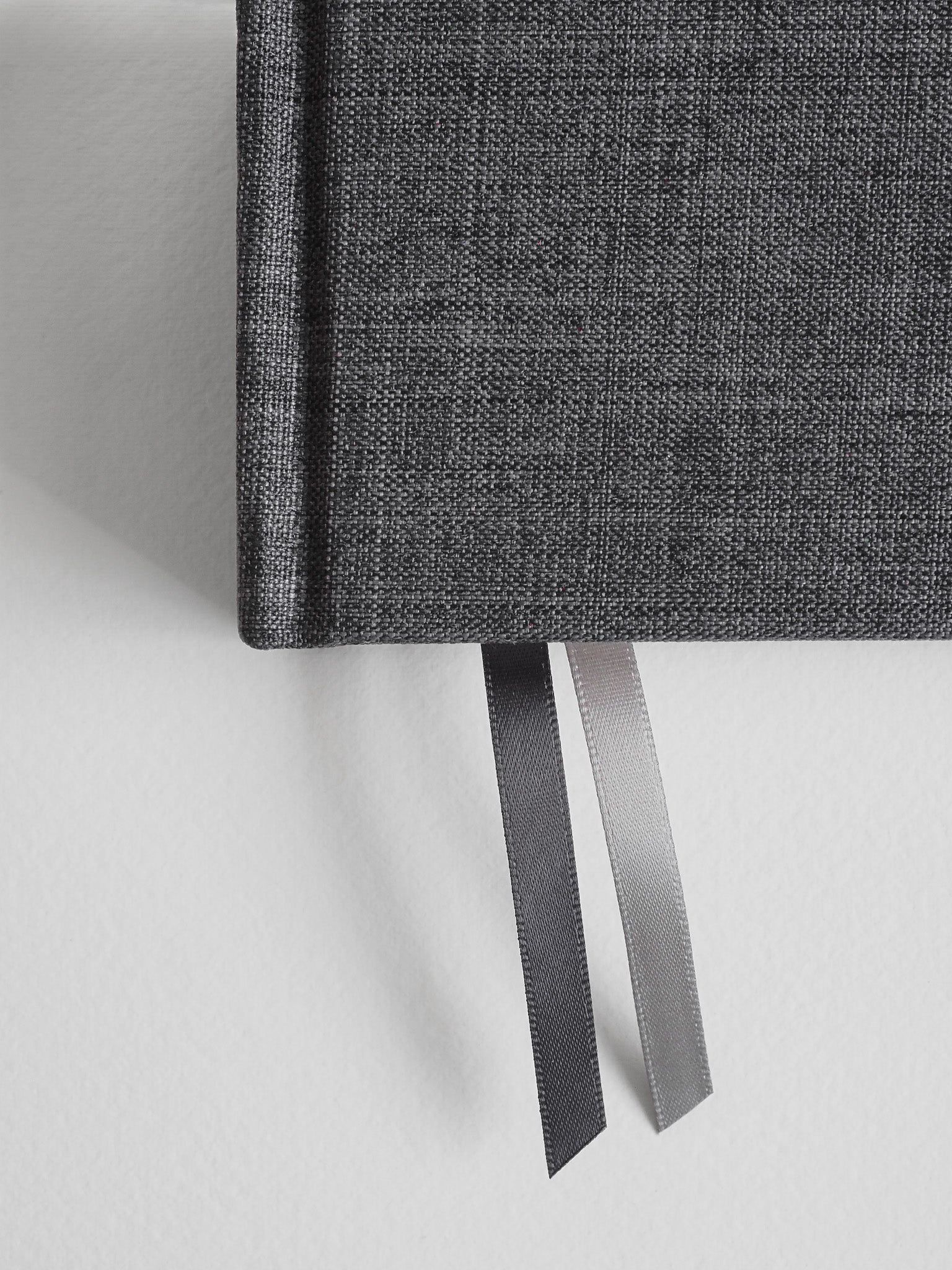 Textured, dark charcoal gray B6 hardcover diary secured with a matching tie ribbon.