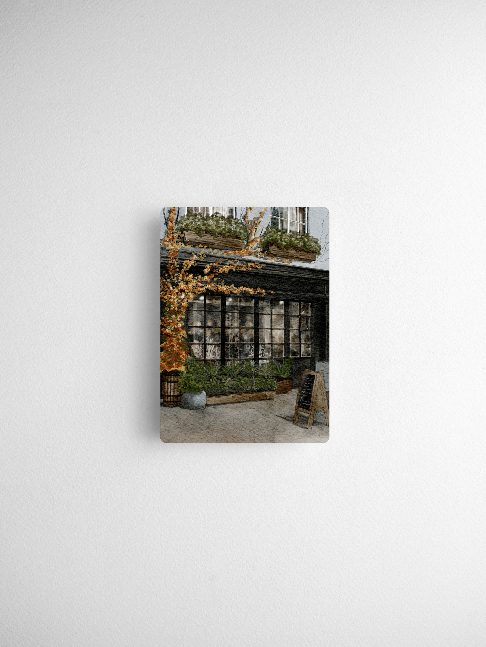 Scenic calendar card capturing a historic European storefront adorned with vibrant seasonal autumn foliage and windows.