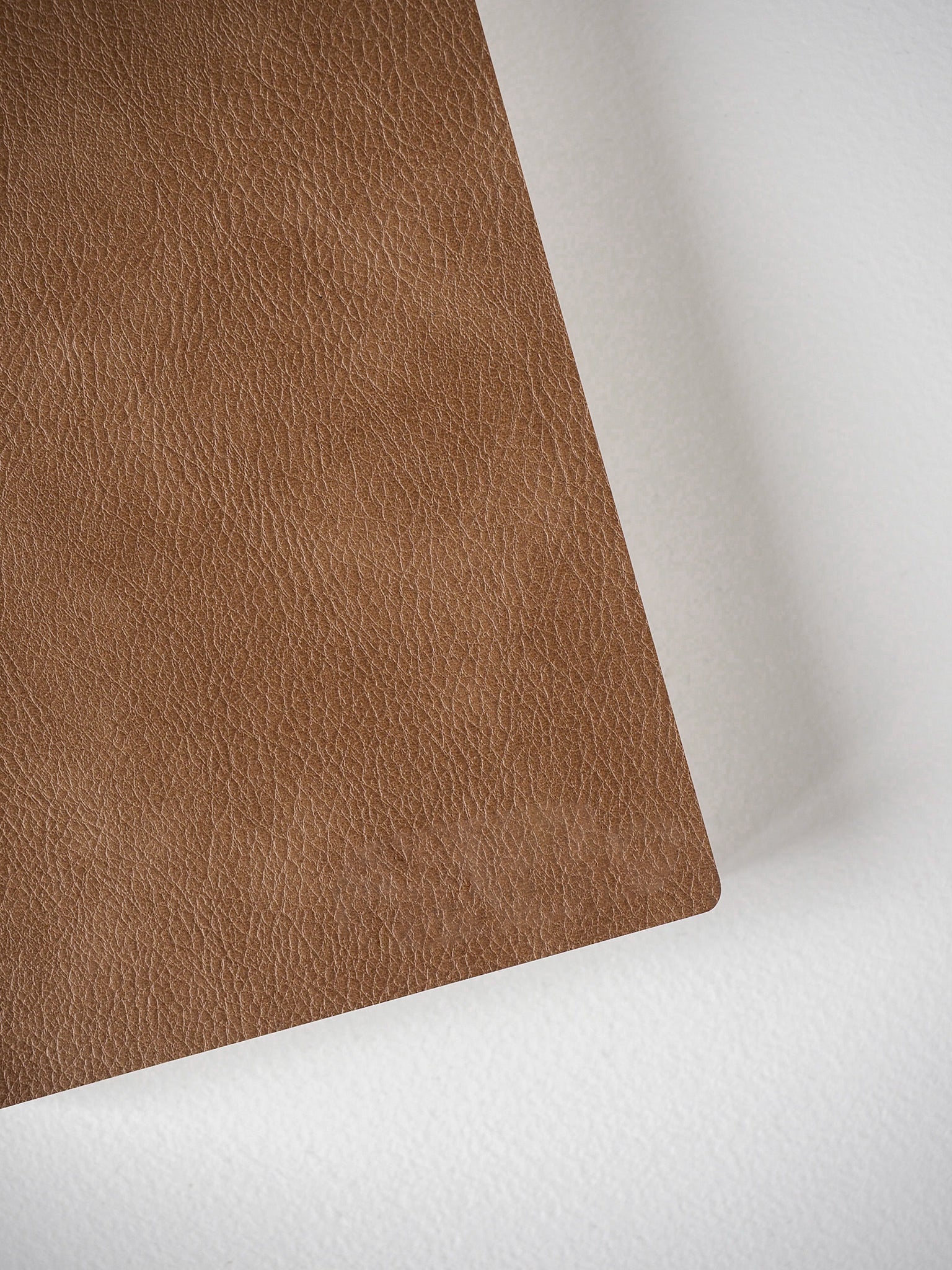 Solid, warm mocha brown grid notebook featuring a richly textured faux leather cover, perfect for standard size planning and journaling.