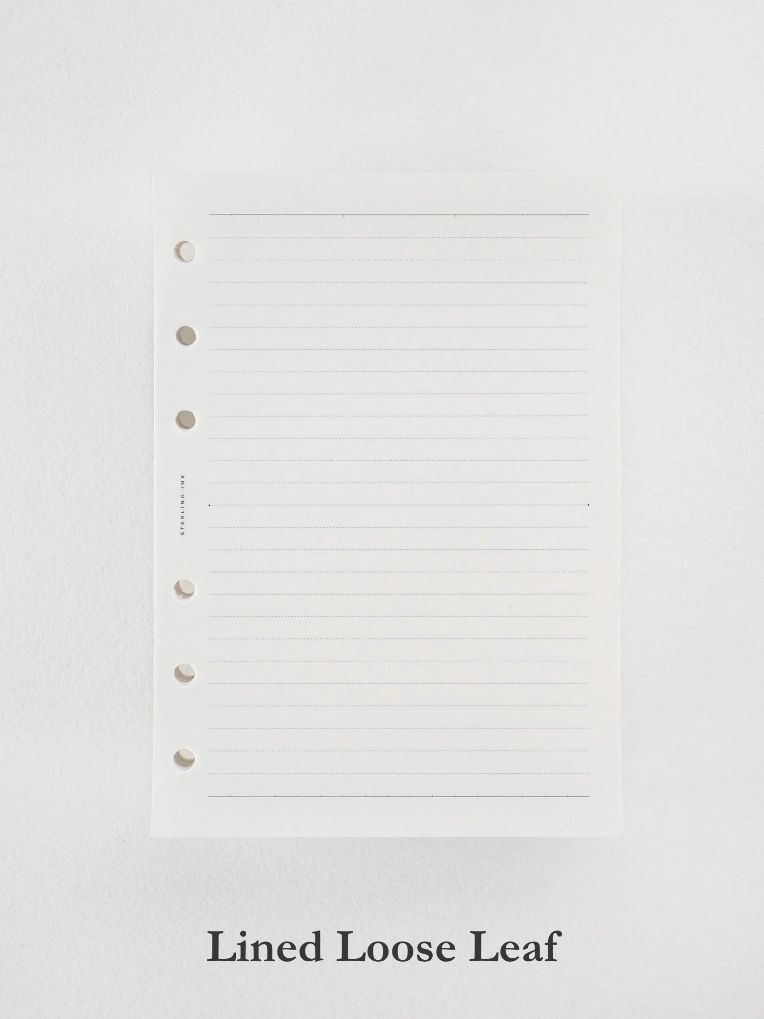 Crisp white loose leaf paper featuring uniform horizontal guidelines and three punched binder holes, ready for writing and organization.