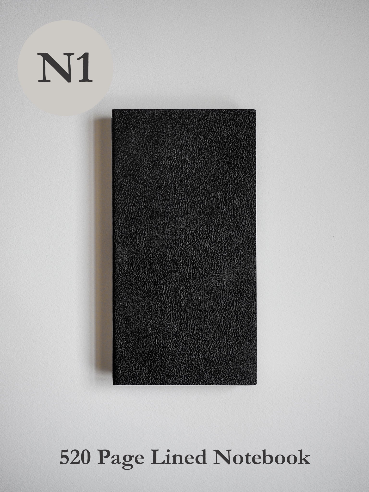 Black notebook with a sophisticated, matte finish and fine, pebbled faux-leather texture, designed for writing and journaling.