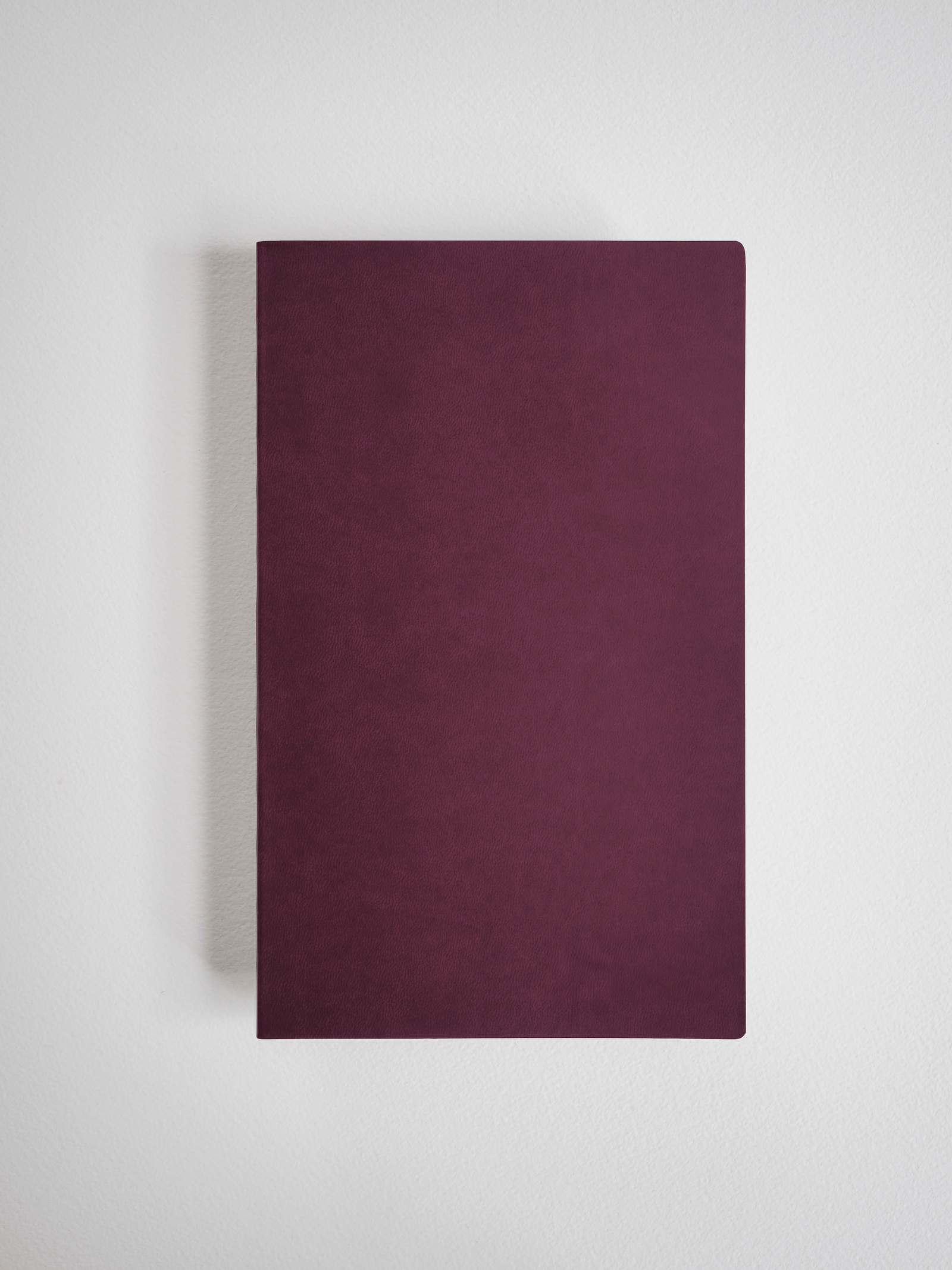 A solid A5 grid notebook featuring a rich, deep burgundy cover for writing, journaling, or planning with 272 pages.