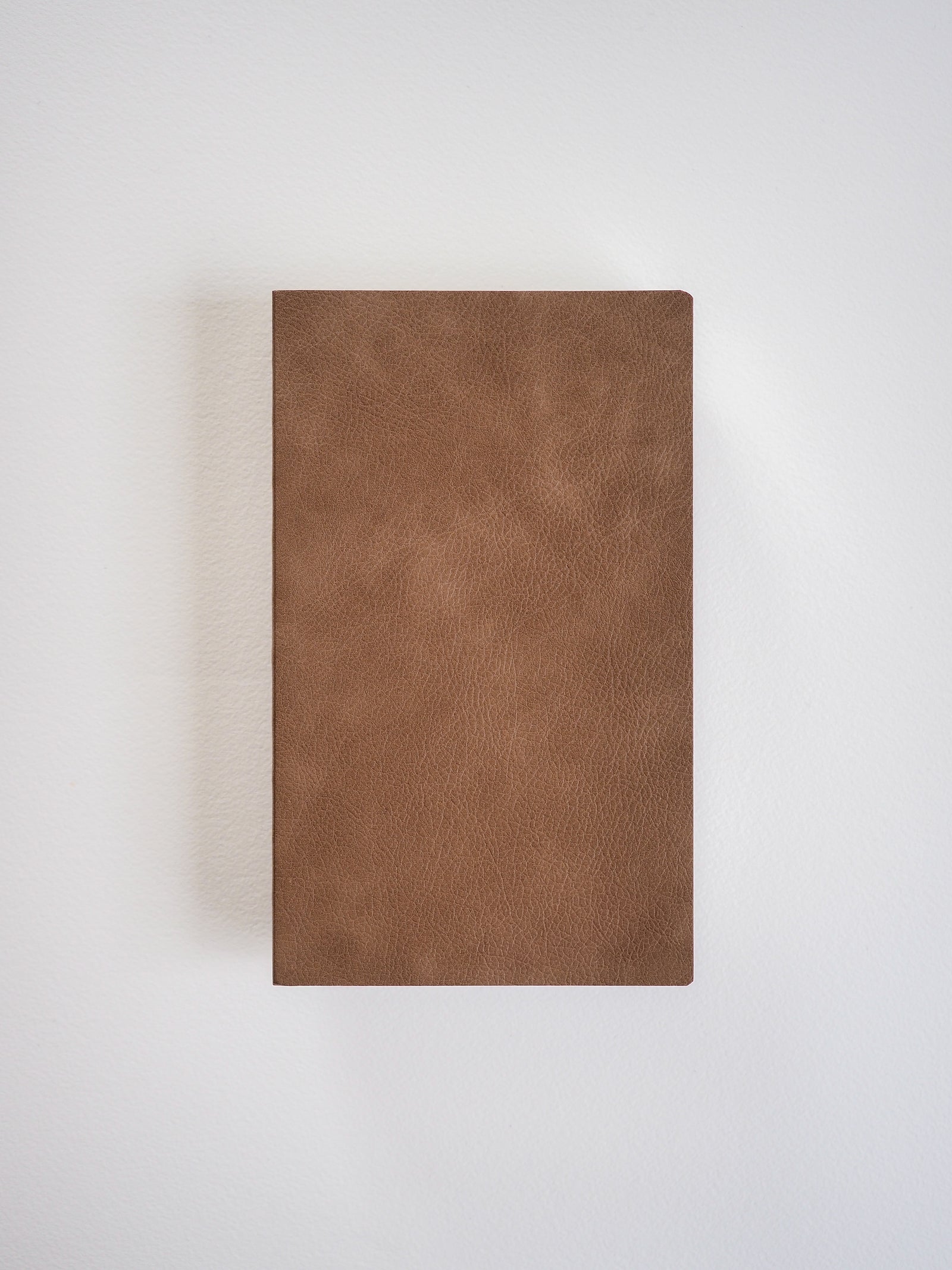 Solid, matte brown B6 grid notebook featuring a minimalist, uniform cover ideal for journaling or daily planning.