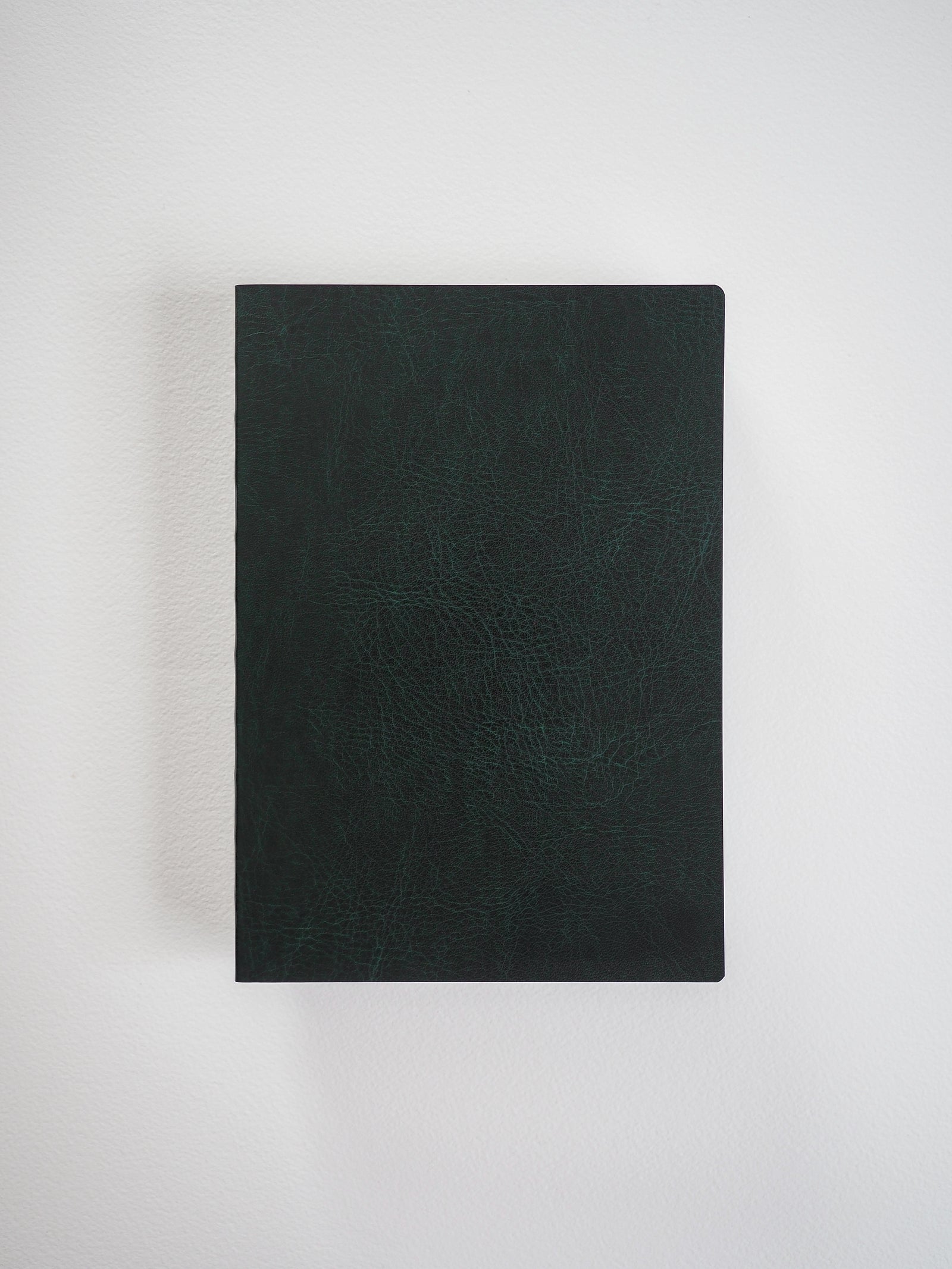 Deep black B6 grid notebook featuring a textured, durable cover, ideal for detailed journaling, work notes, and planned organization.