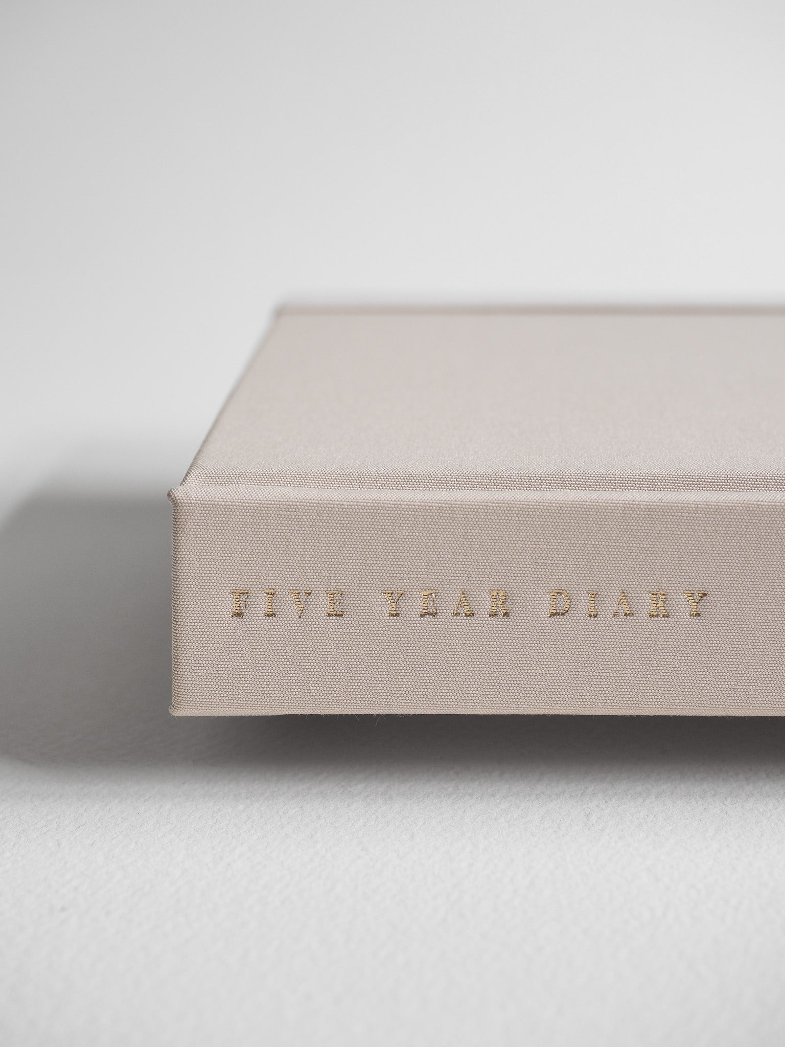 Minimalist B6 hardcover diary in a natural beige tone, featuring "Five Year Diary" subtly embossed across the center.