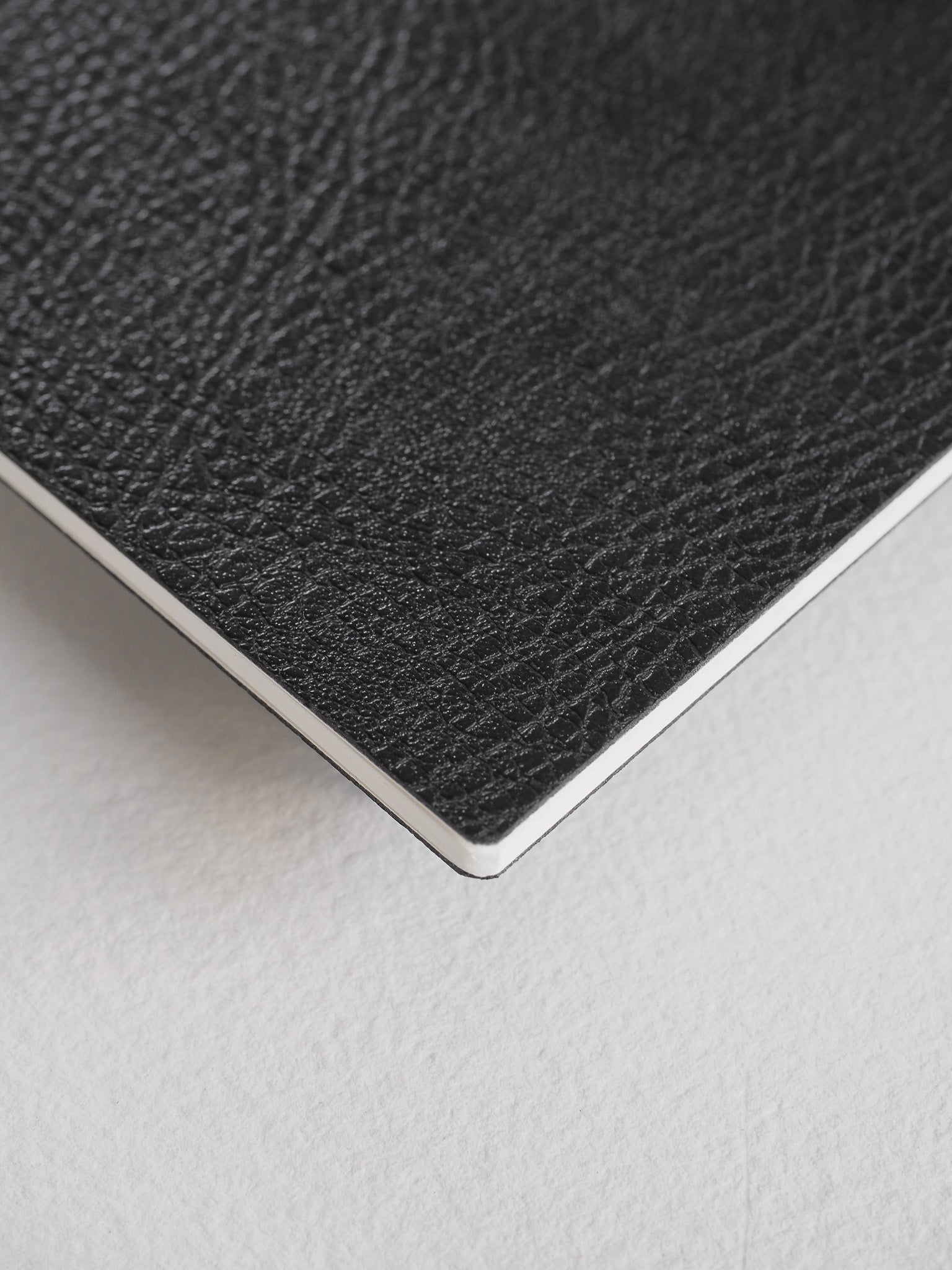 Sleek B5 notebook booklet featuring a solid black cover with a subtle, fine-grain textured finish.