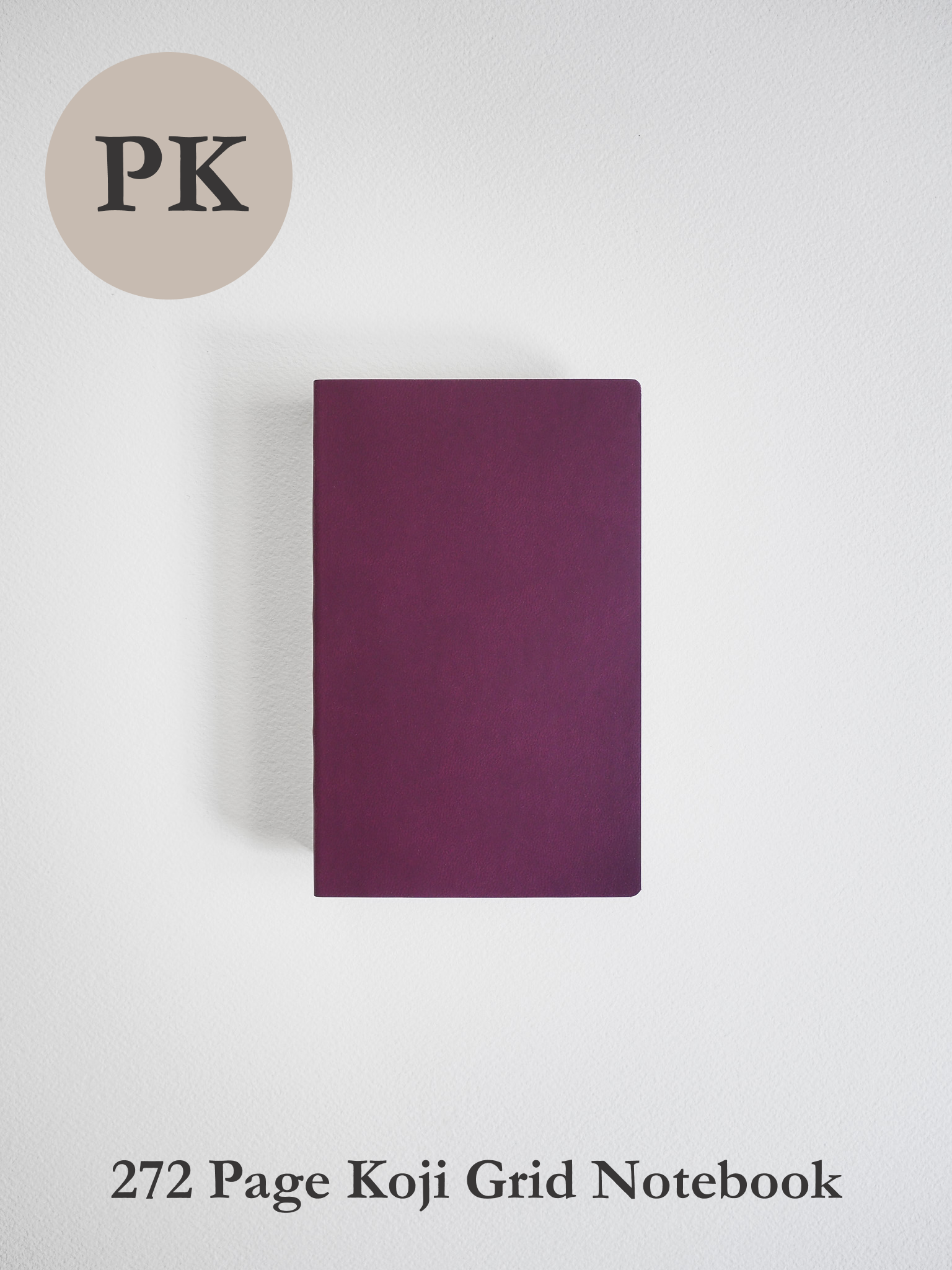 Minimalist pocket notebook with a solid, deep plum-colored cover, featuring 272 pages designed for organized grid note-taking.