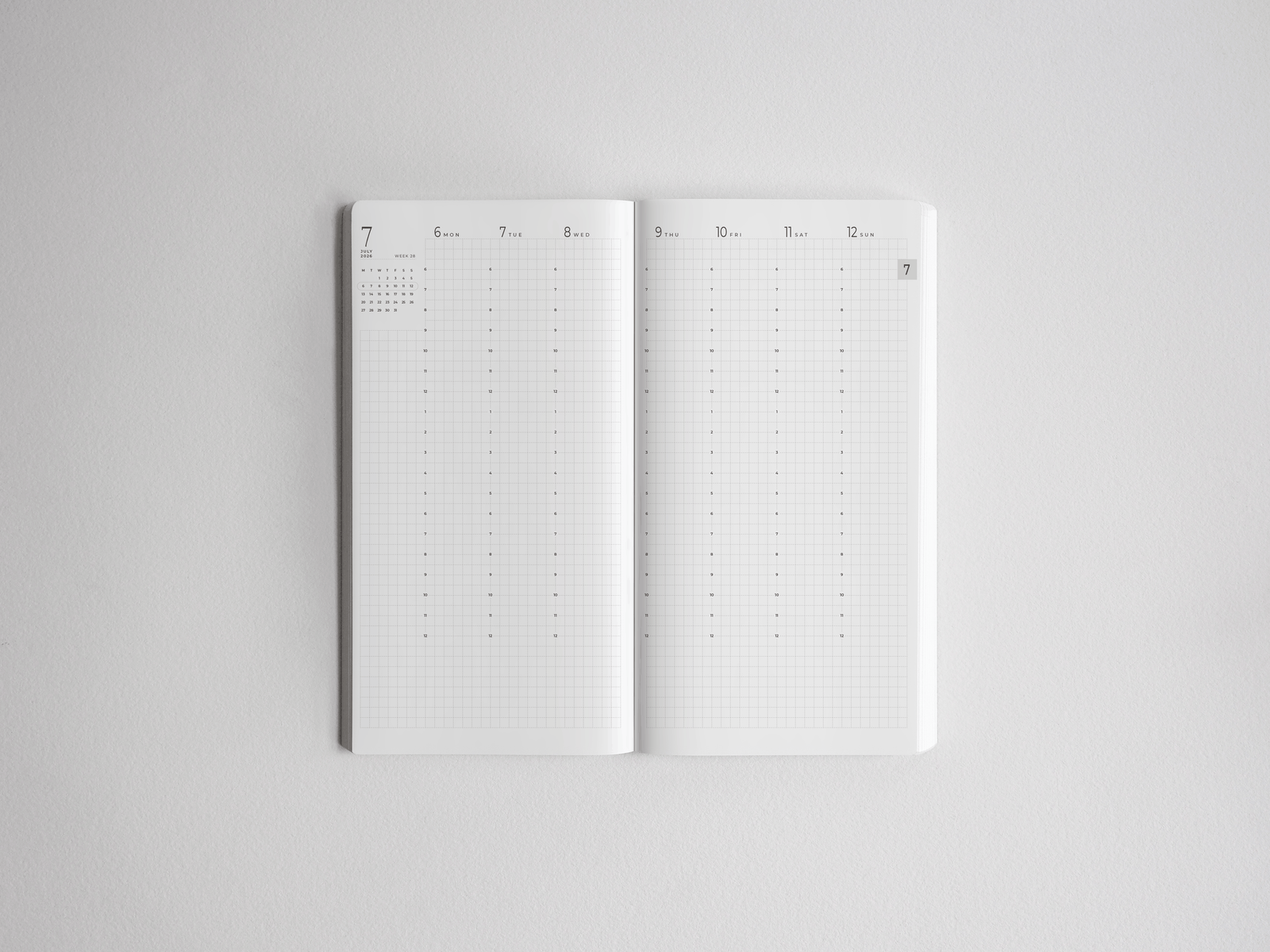 Open white academic planner displaying a clear, minimalist weekly spread grid ready for scheduling the 2026-2027 academic year.