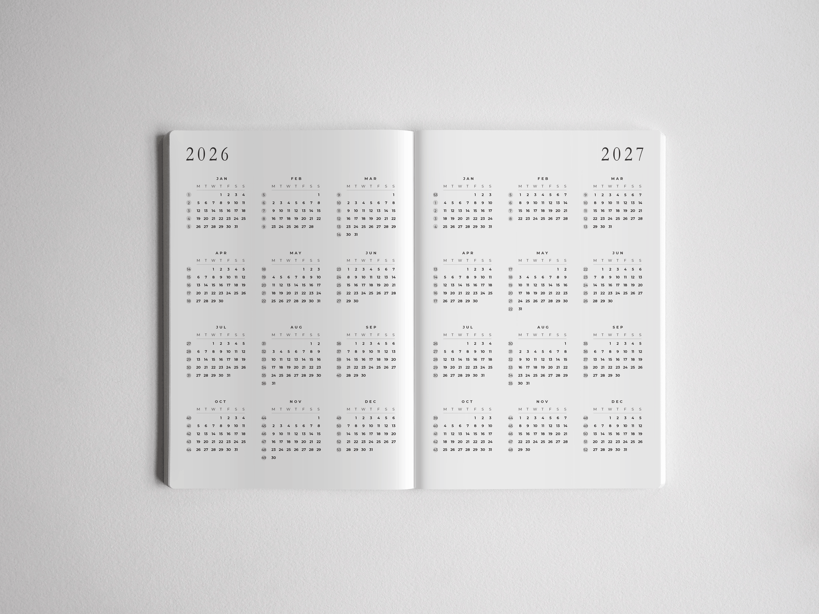 Academic A5 daily planner displaying a comprehensive two-year calendar grid for 2026 and 2027, featuring minimalist black text and highly structured monthly date layouts.