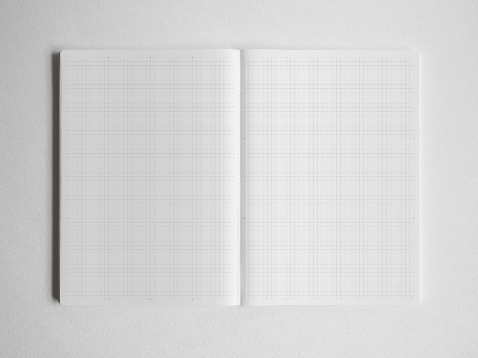 Open academic planner showing a versatile two-page spread: one side of blank paper and the other side featuring white graph grid paper for detailed notes and planning.