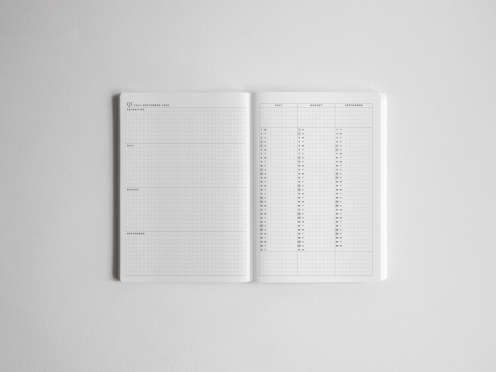 A vertically oriented B6 academic planner open to a monthly calendar spread with crisp white ruled pages for detailed year planning and organization.
