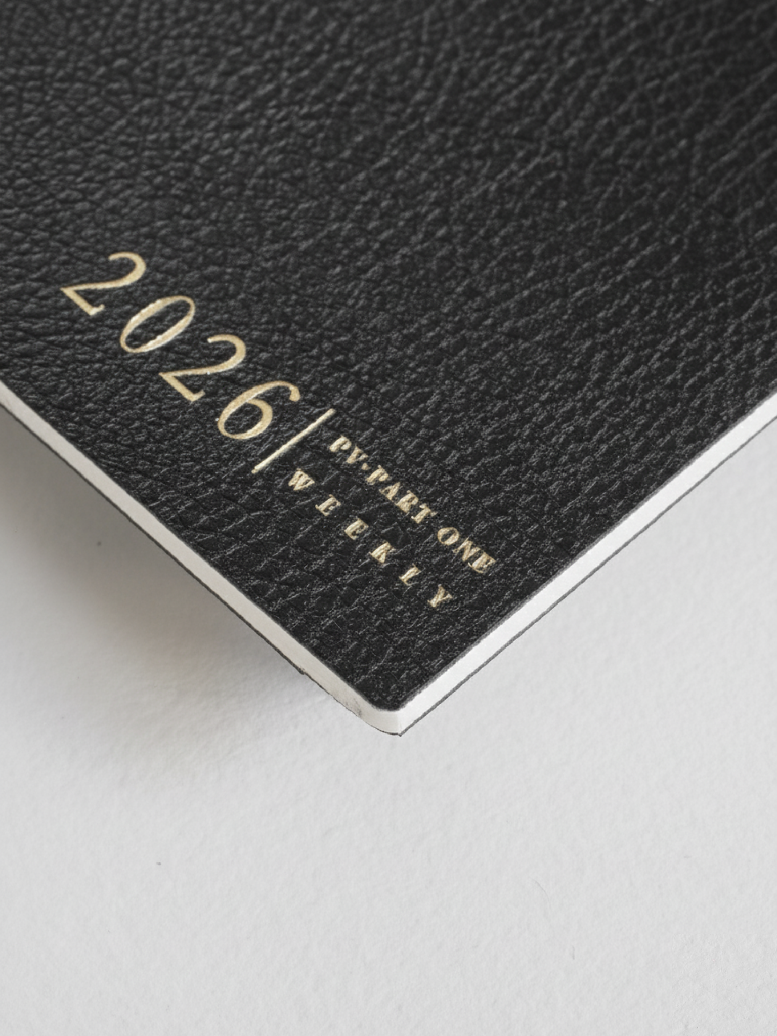 Minimalist black weekly planner cover featuring elegant debossed metallic lettering for "2026 | PV PART ONE WEEKLY."