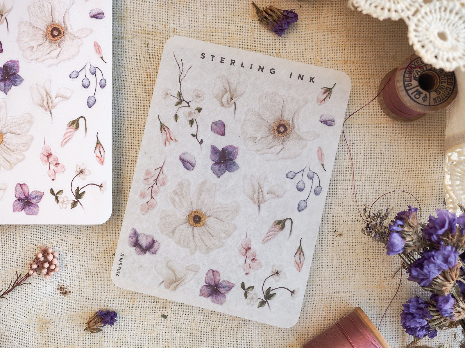 Delicate watercolor botanical elements featuring soft mauve and blush illustrations of various blooms, leaves, and trailing berries.