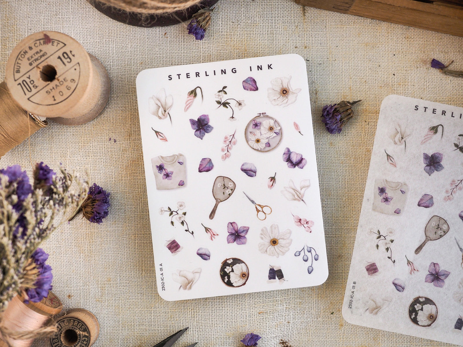Pastel watercolor sticker sheet displaying a collection of botanical icons, including small purple flowers, delicate leaves, vintage scientific tools, and natural elements.