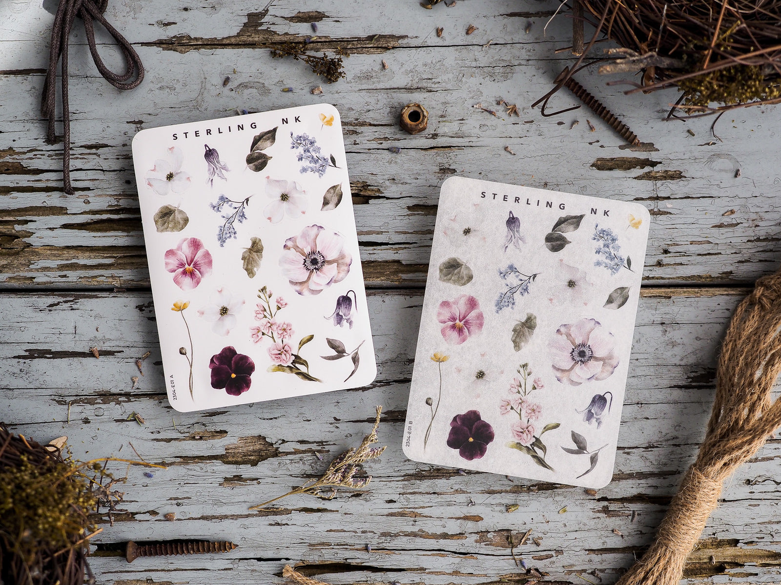 Delicate botanical sticker set featuring watercolor elements of soft pink, purple, and cream blossoms, surrounded by detailed foliage.