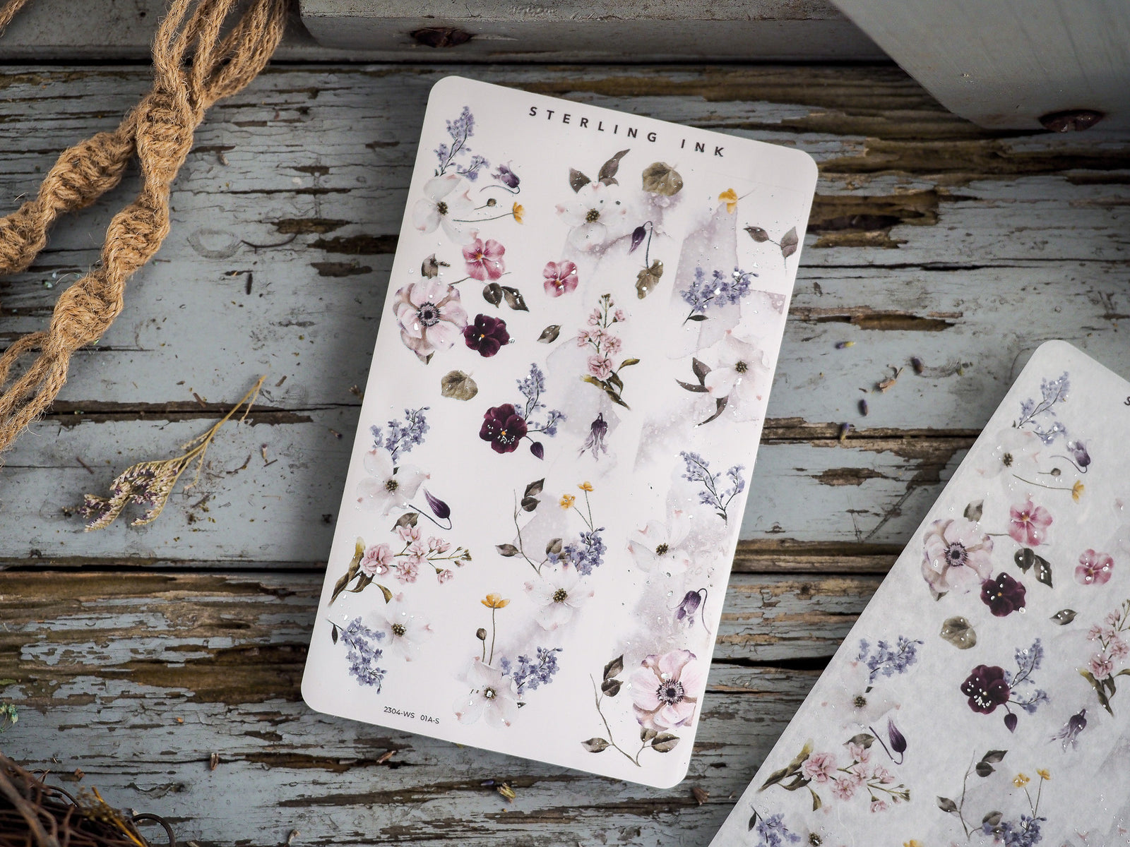 Stationery featuring a soft pastel watercolor botanical pattern with delicate groupings of purple, pink, and lavender wildflowers.