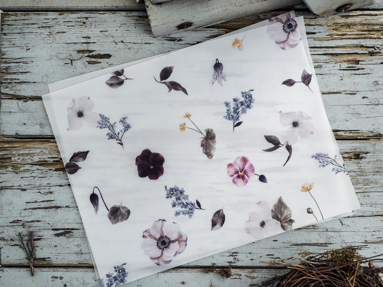 Botanical watercolor sheet featuring muted spring florals, including soft pink peonies, delicate blue sprigs, and complementary gray-green foliage.
