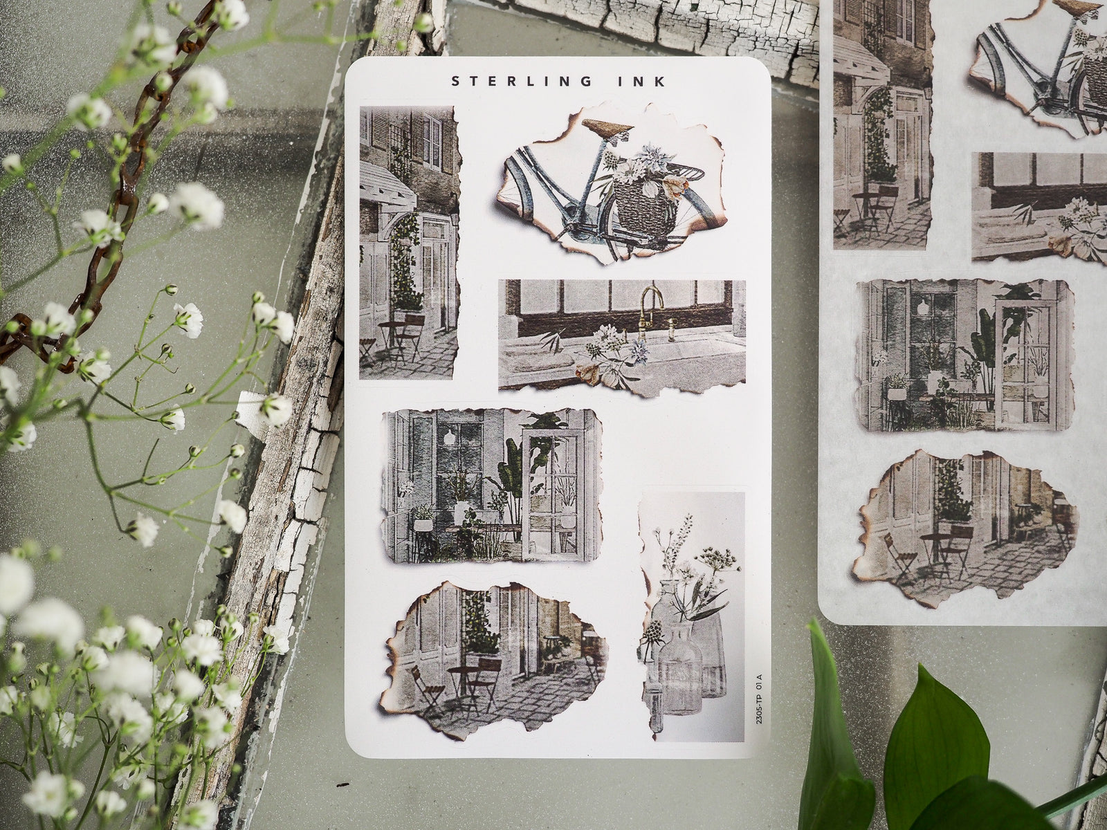 Collection of torn paper stickers featuring black-and-white sketches of quaint street shops, evoking a vintage European architectural and cozy town theme.