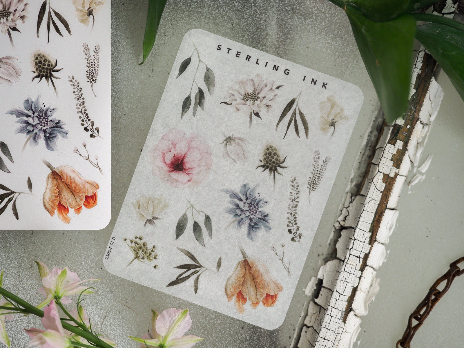 Botanical elements sticker sheet featuring vintage illustrations of flowers, leaves, and plants in muted tones of dusty blue, blush pink, and terracotta.