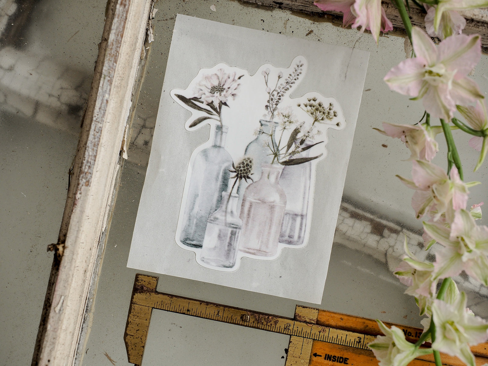 Monochromatic die-cut sticker sheet displaying delicate botanical bouquets with white flowers in various pale glass vases.