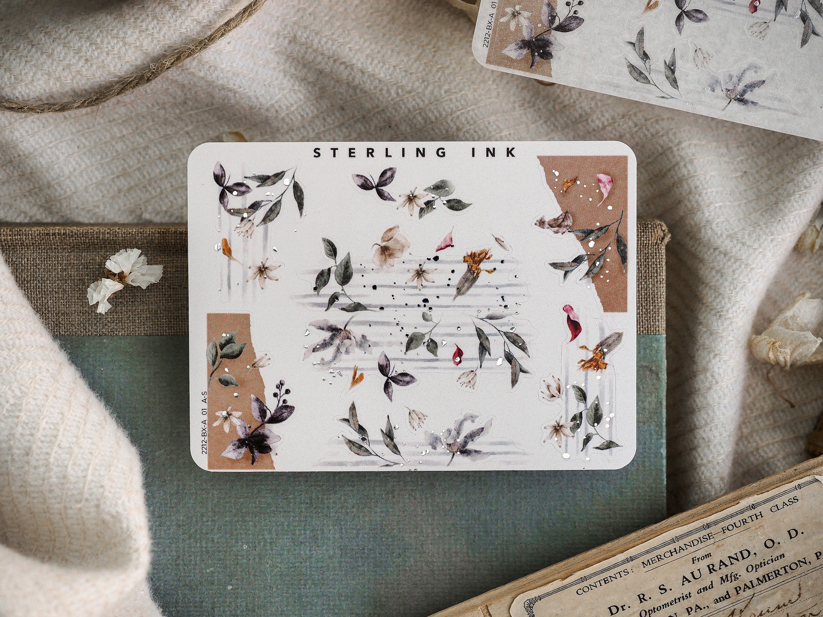 Delicate sticker sheet featuring clusters of realistic botanical designs, including pressed foliage and muted blooms, suitable for decorating edges and corners.