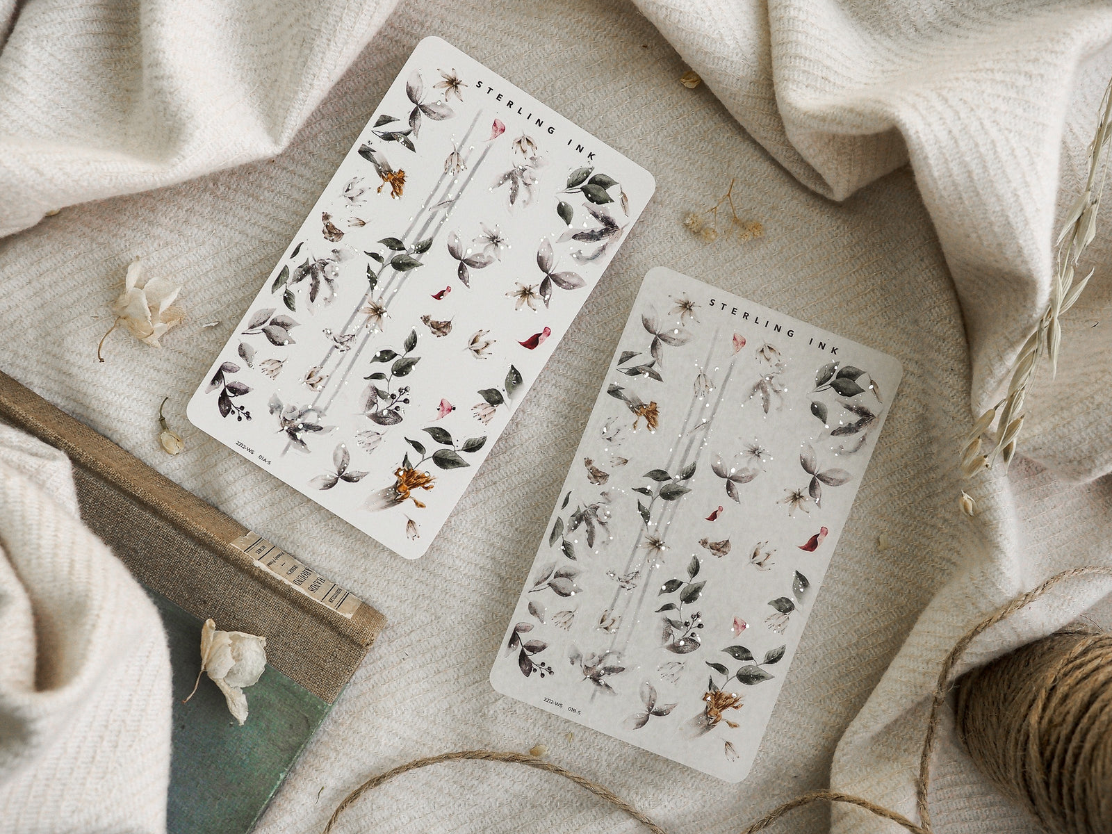 Detailed washi sticker sheets for journaling, featuring delicate decals of dried autumnal florals, leaves, and natural seasonal sprigs in muted earth tones.