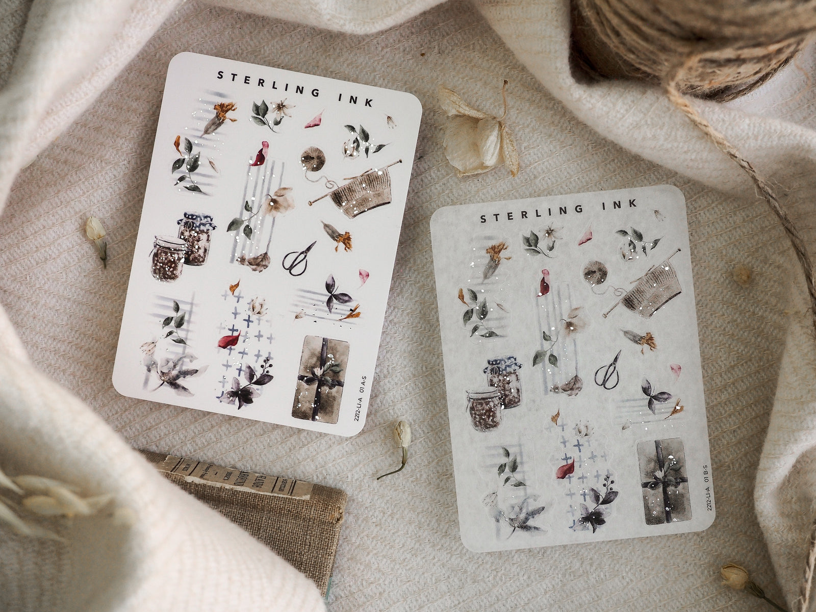 Decorative icon sticker sheets featuring seasonal metallic illustrations, including silver foil accents on detailed drawings of leaves, small pots, and festive elements.